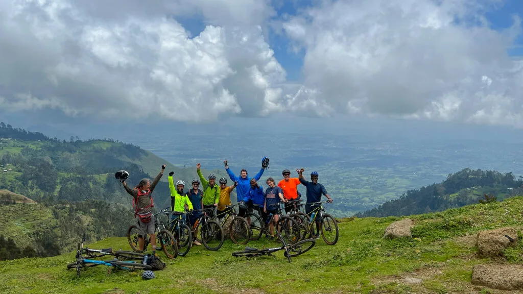 Cyclists celebrating on the Rift Valley escarpment near Terega in Ethiopia