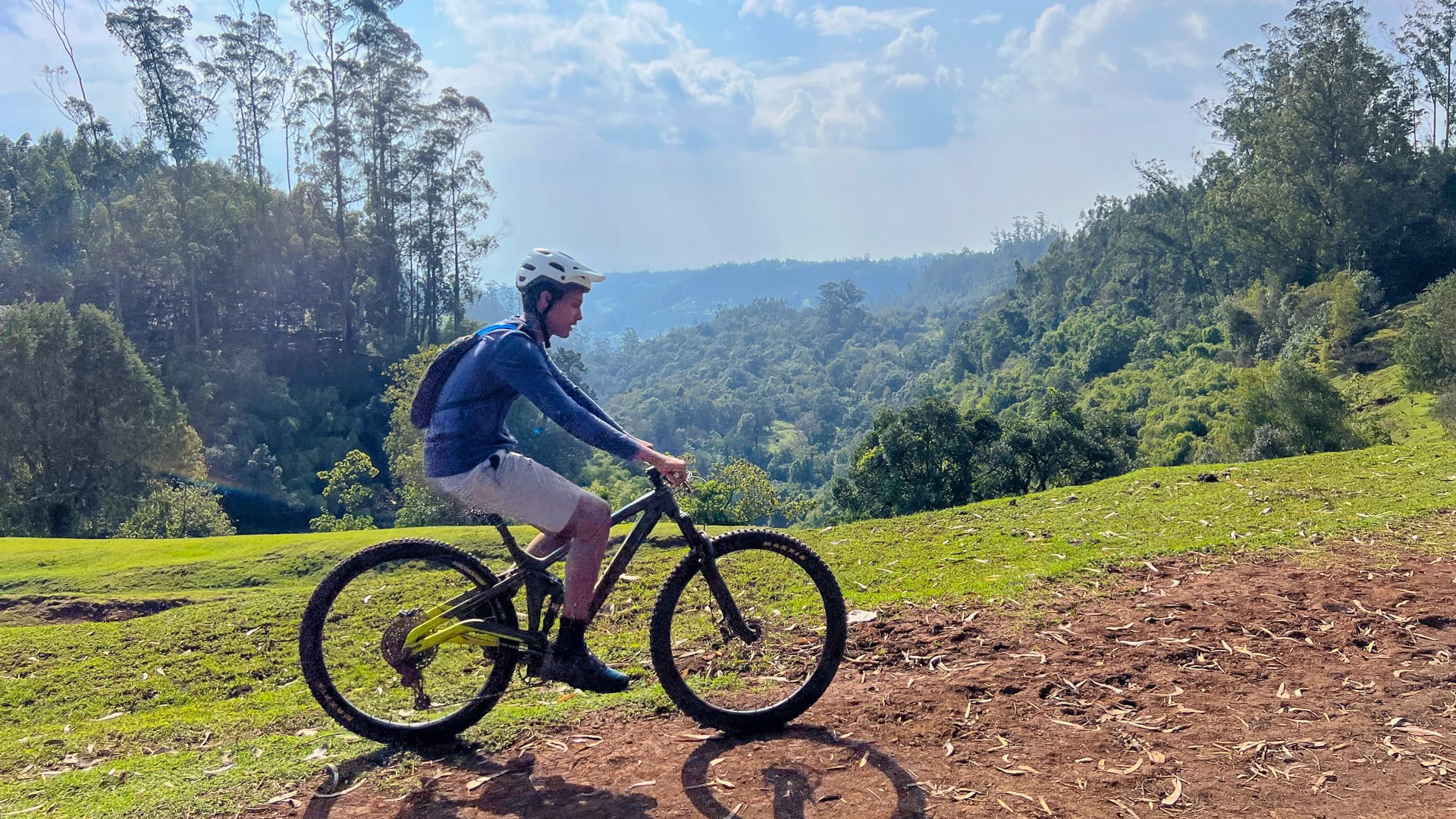 Cyclist riding across rocky terrain on a mountain bike during a cycling trip in Ethiopia