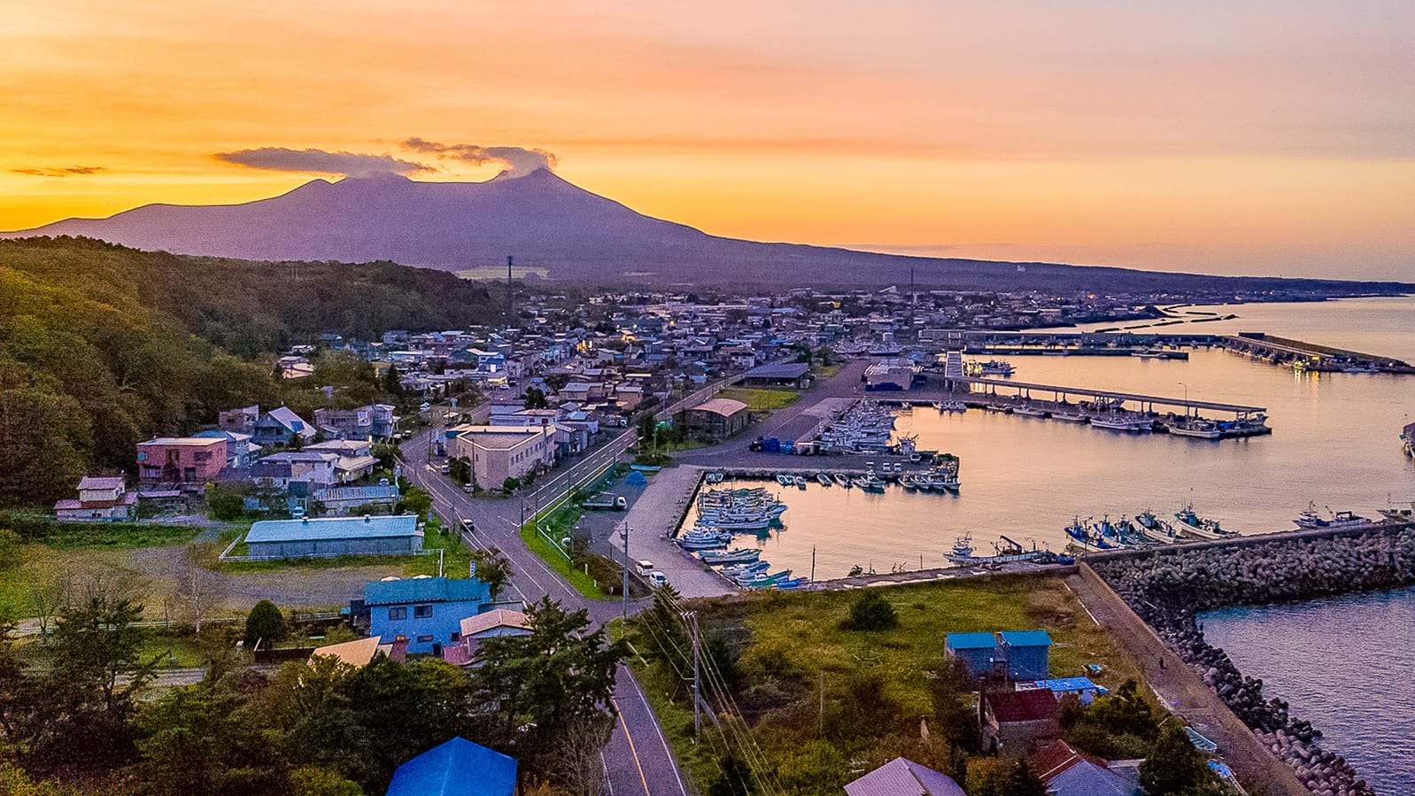 Peaceful coastal town and harbour below in Hokkaido Japan