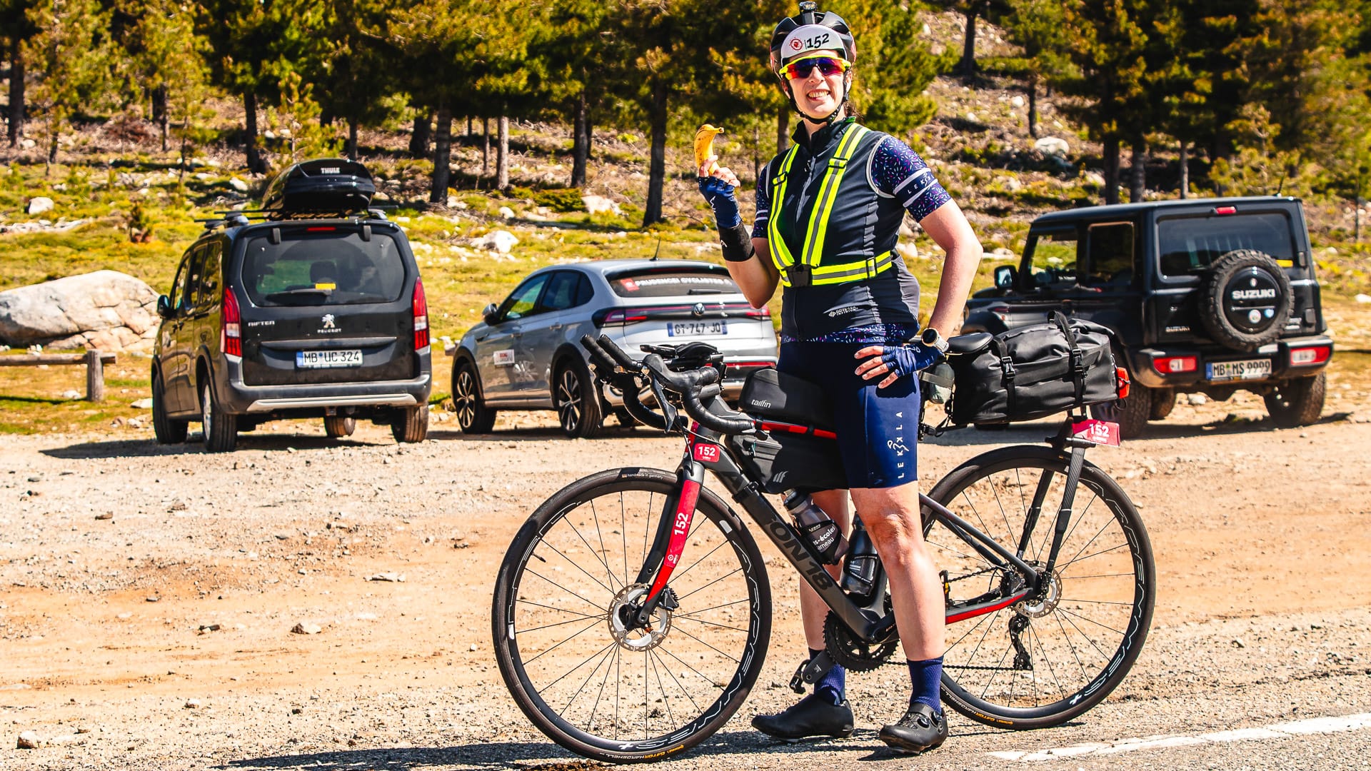 Cyclist taking a snack break at the top of Vergio Pass during a long-distance ride in Corsica