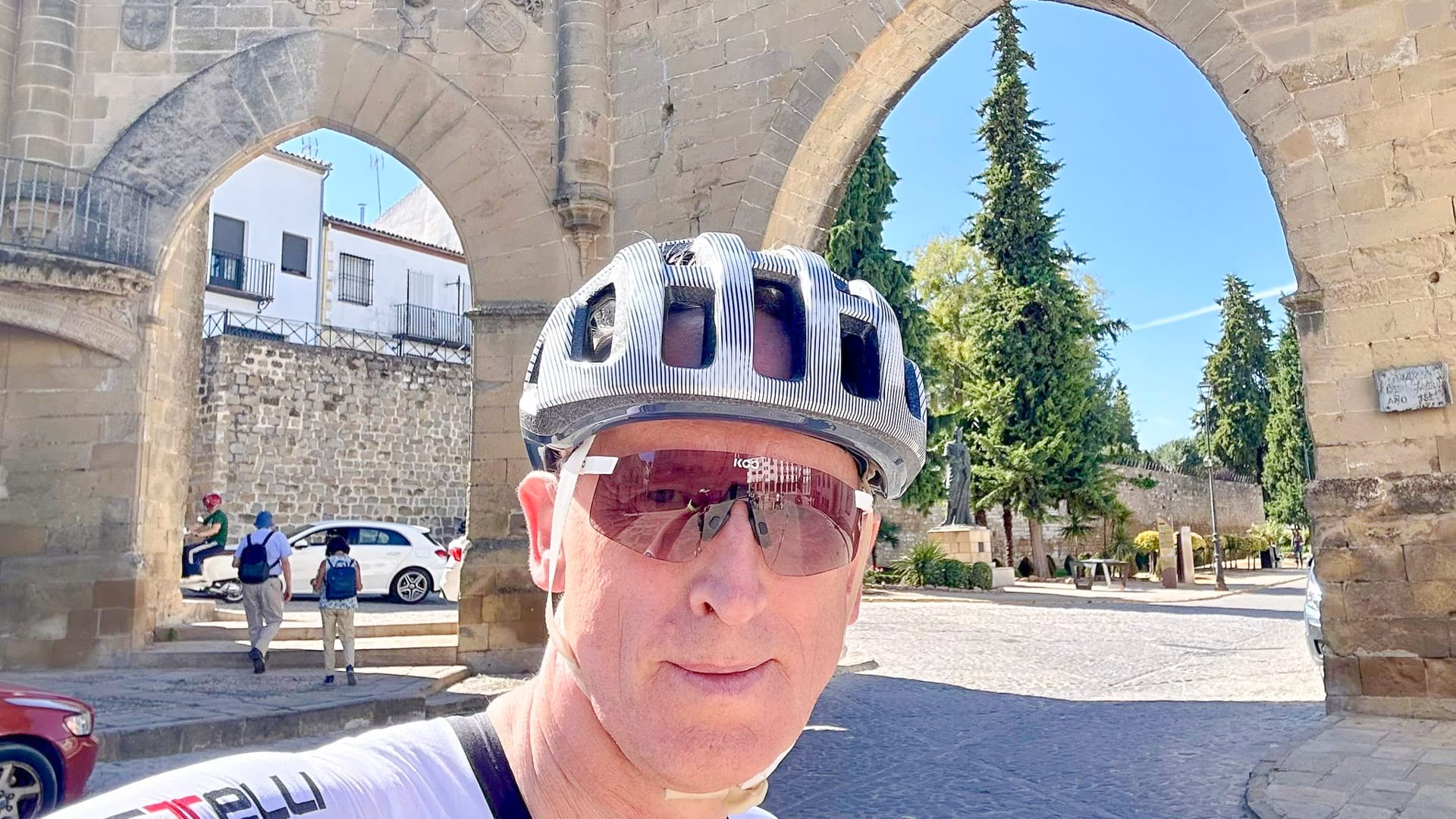 Cyclist taking a photo in the historic town of Baeza, Andalusia, Spain