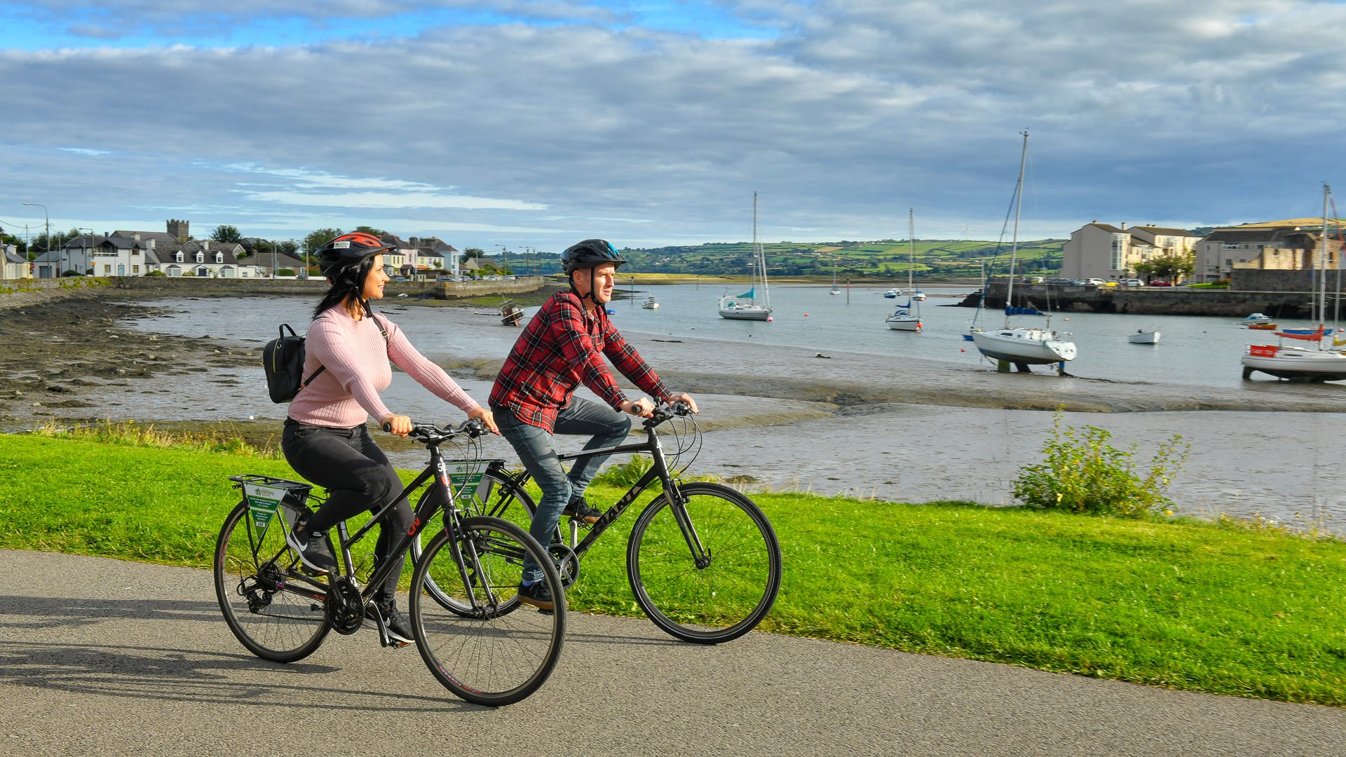 Couple cycling through Dungarvan in County Waterford, Ireland