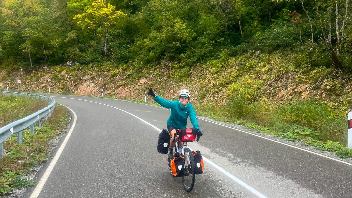 Cyclist gliding down the hill while riding in Georgia and Armenia
