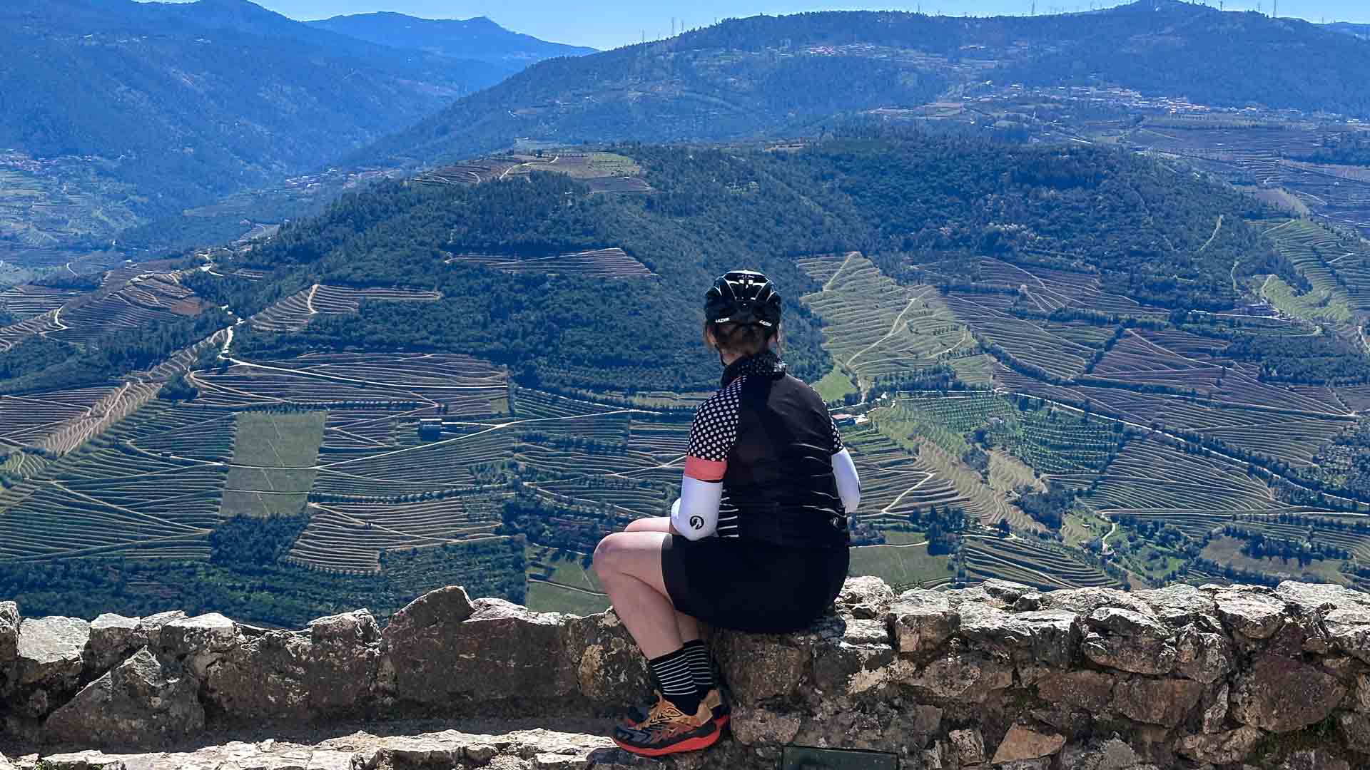 Cyclist admiring the landscape views over the Douro Valley from a viewpoint in Portugal