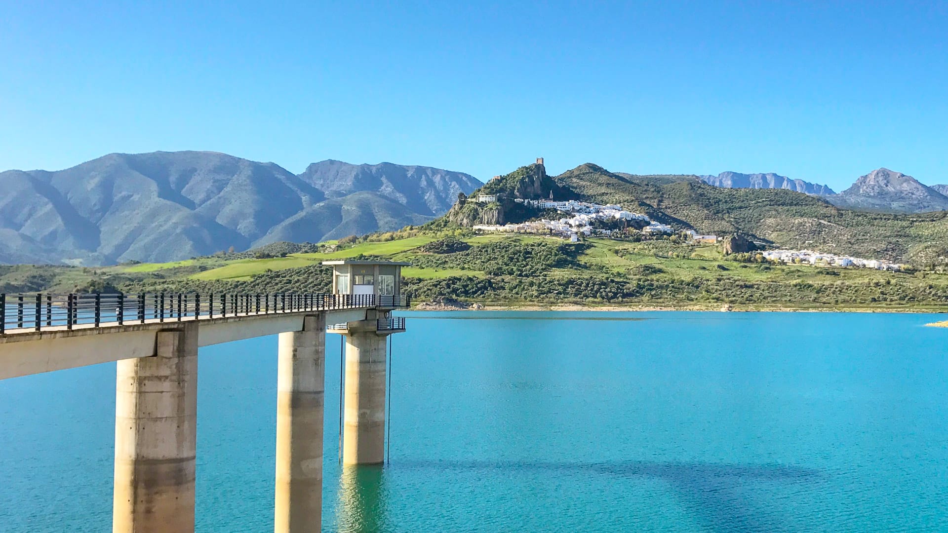 View of Zahara de la Sierra with its hilltop village and reservoir in the Grazalema mountains, Spain