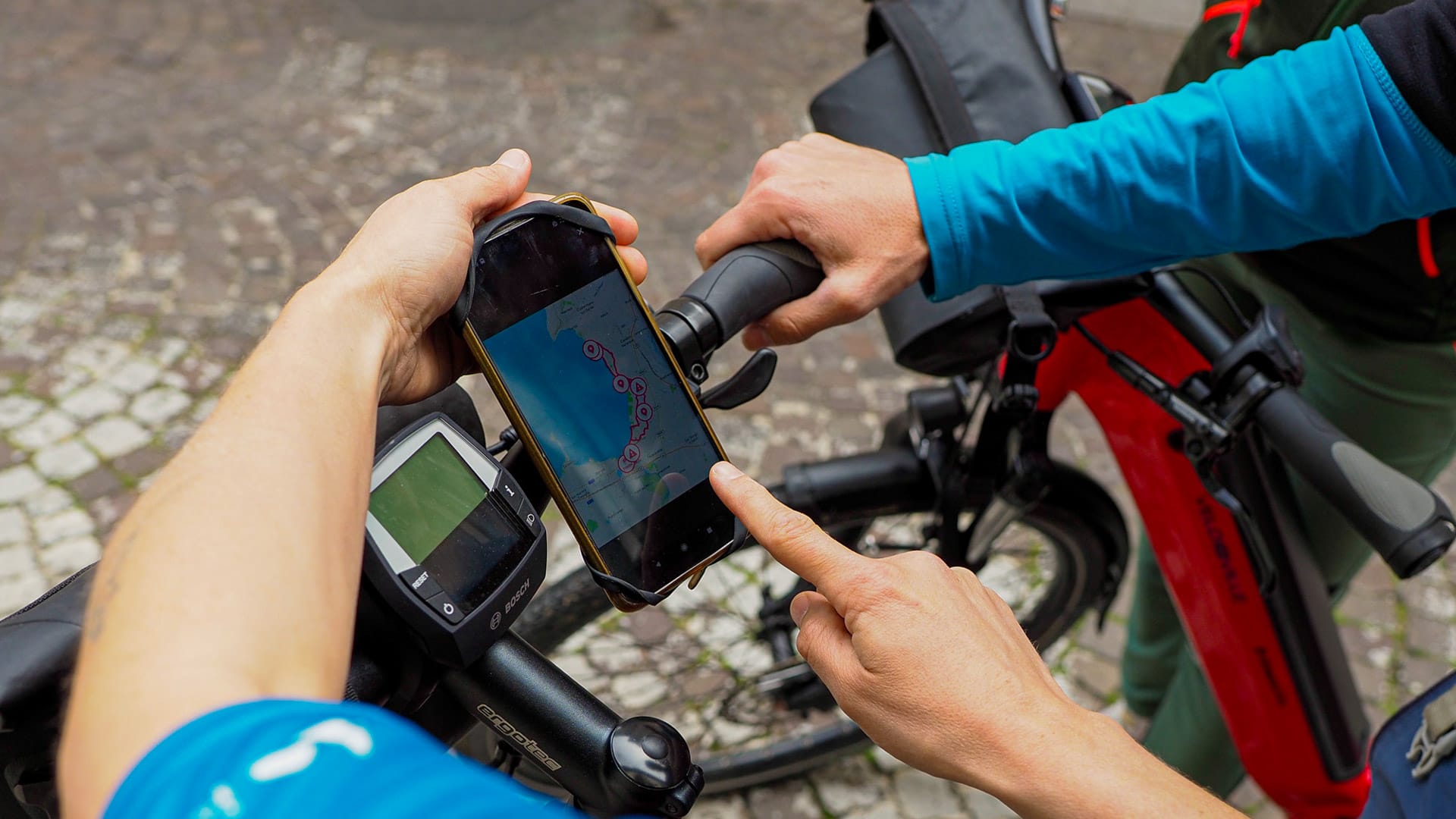 Cyclist checking the route map on their phone while riding