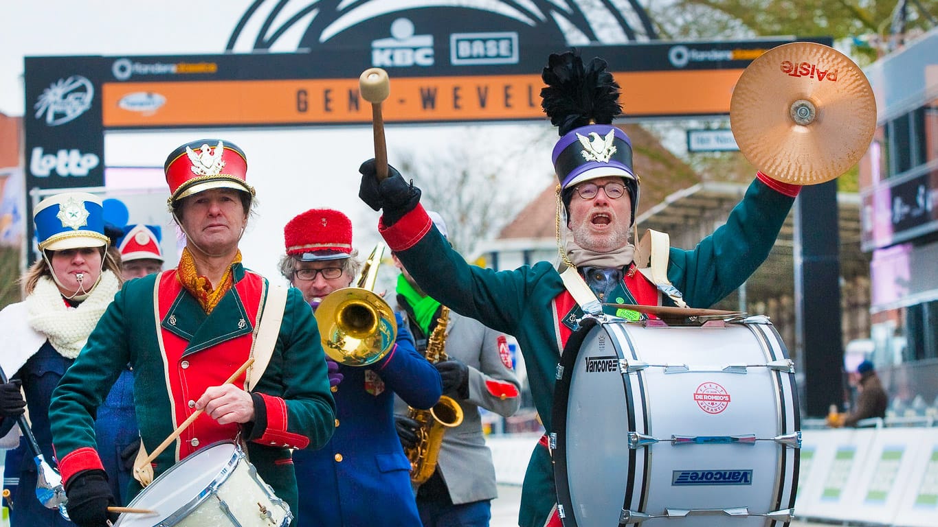 Some people are playing band on the Belgium bike tour road