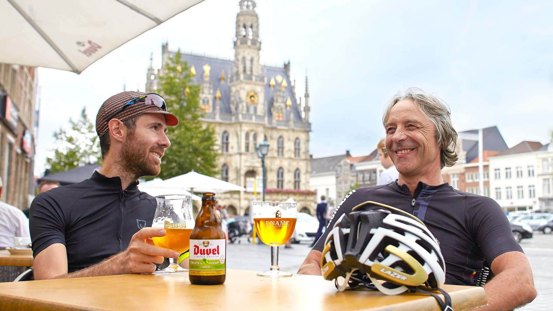 Two cyclists are resting at noon come on bike tour in Belgium 