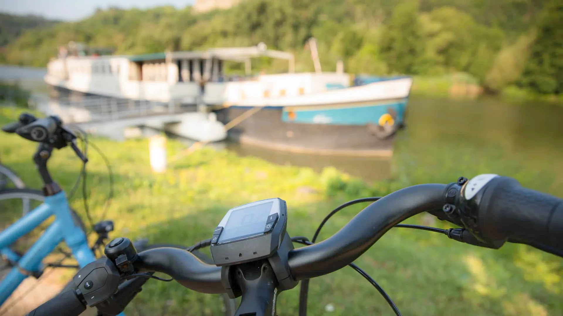Bike handlebar visible while overlooking a boat on a river in Germany