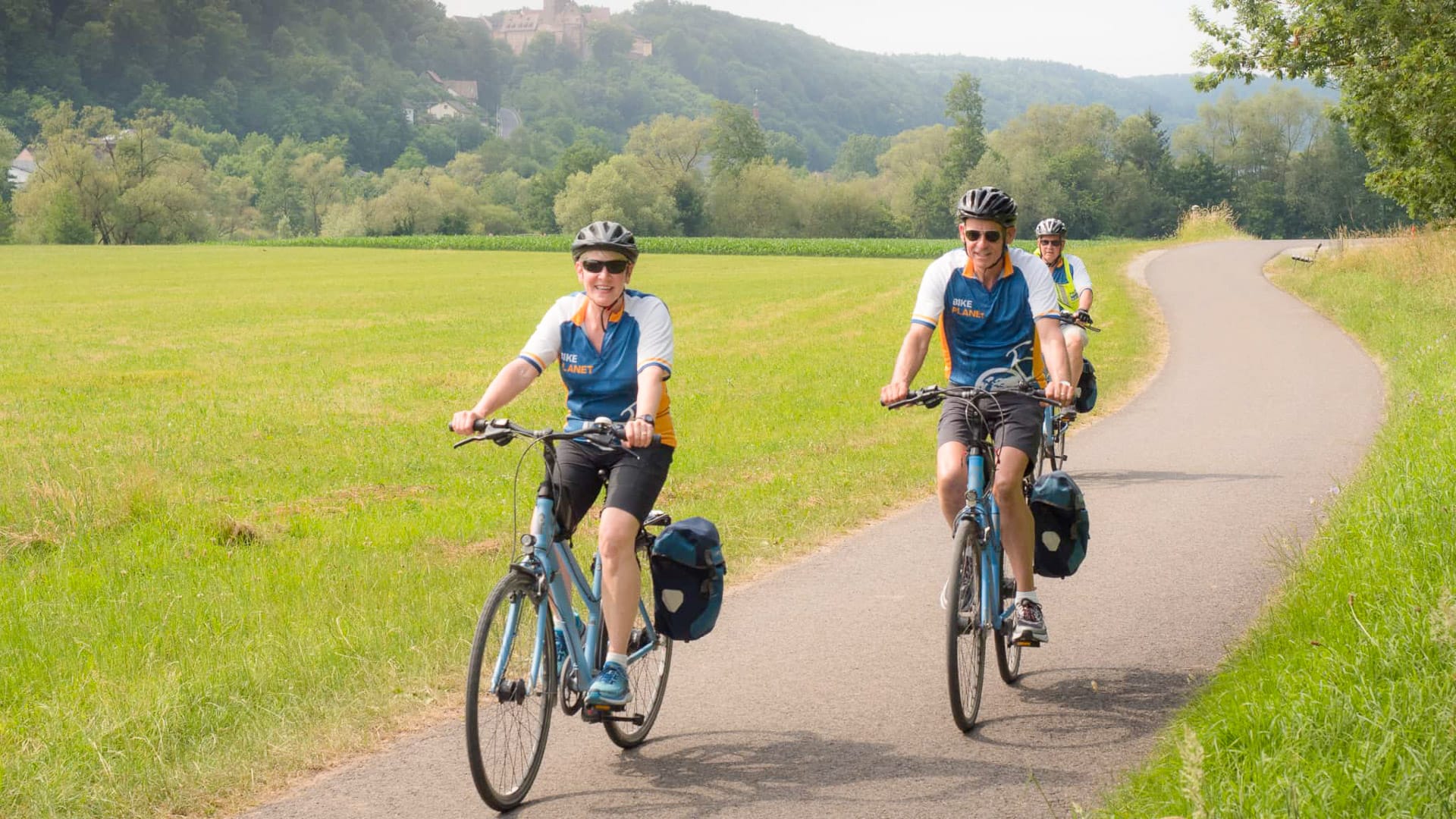 Three cyclists enjoying a quiet path during a tour