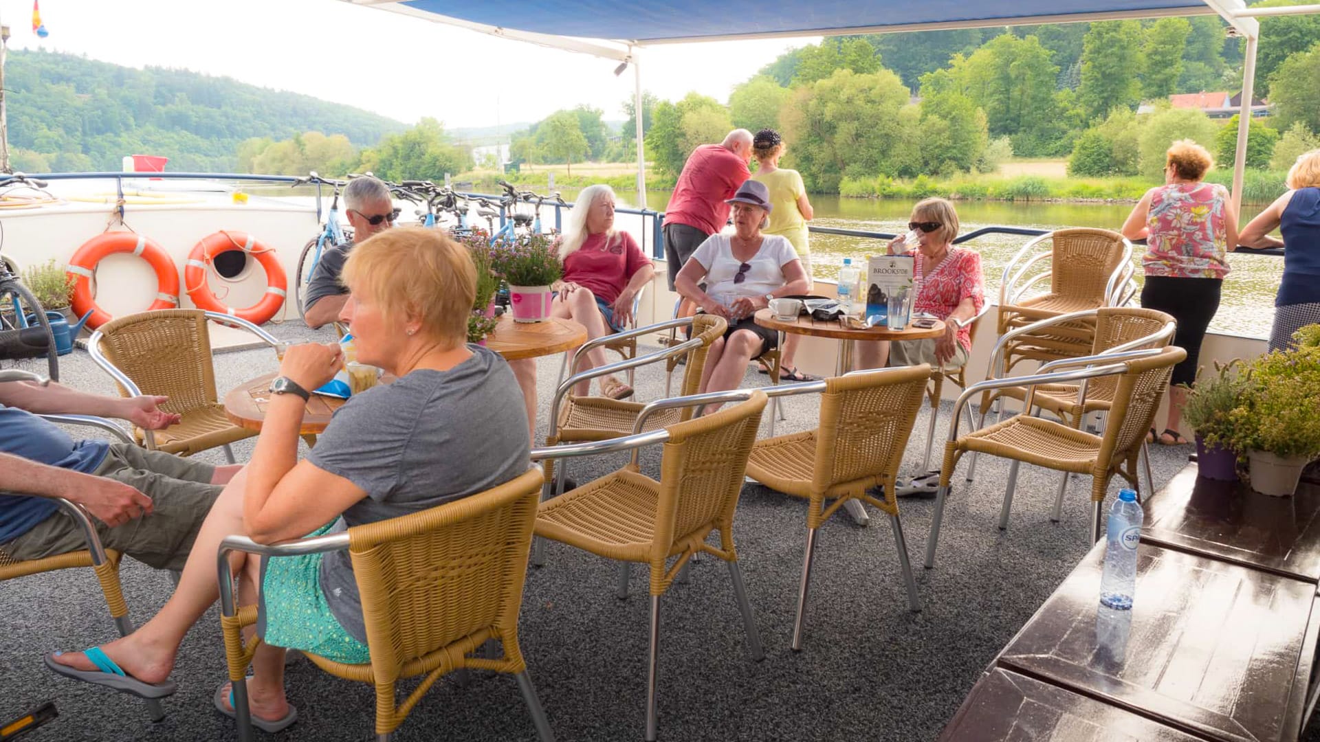 Cyclists enjoying their rest time on a boat during a tour