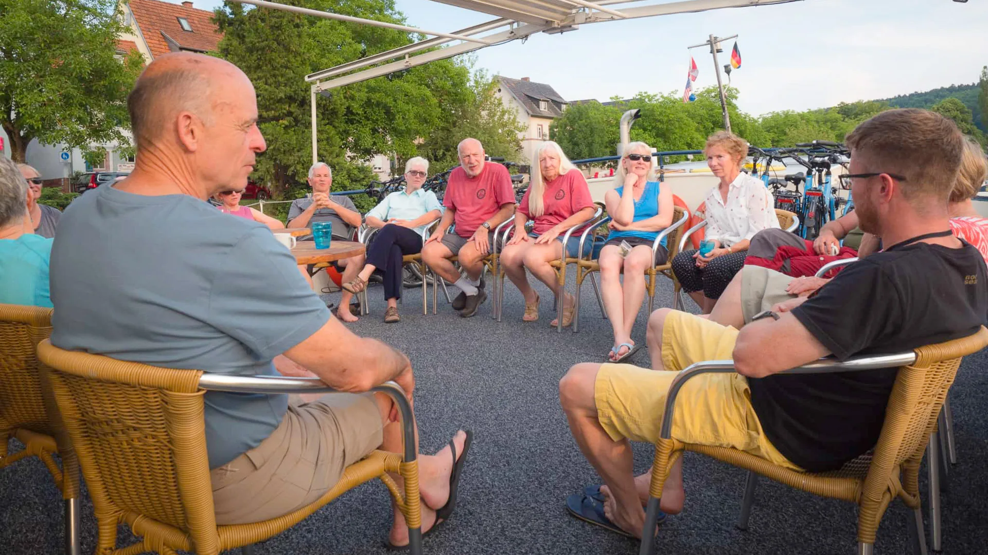 Cyclists relaxing on board of a bike and barge outdoor terrace