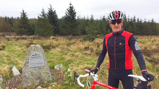 Cyclist at the Shay Elliott (cyclist) Memorial in Wicklow Mountains, Ireland