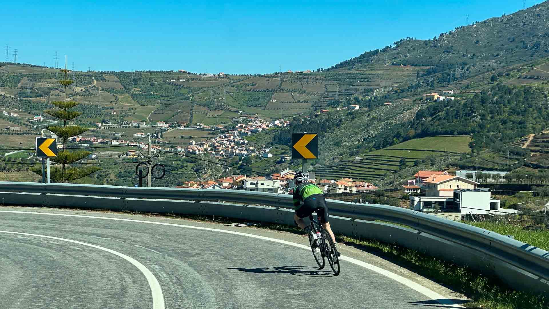 Rider cycling the scenic N2 loop with hillside views in the Douro Valley