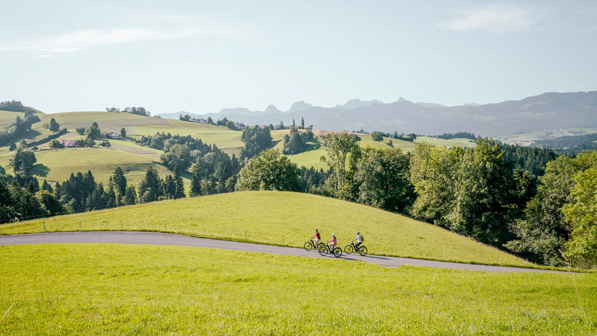 Cyclists exploring the Sagenroute trail in Gantrisch Nature Park, Switzerland