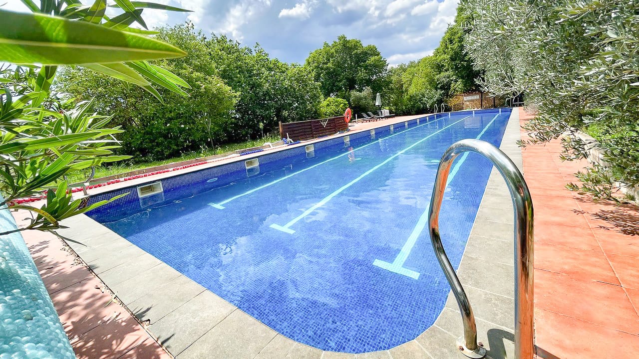 The outdoor pool at Hotel Mas Pelegri offers a relaxing space to unwind