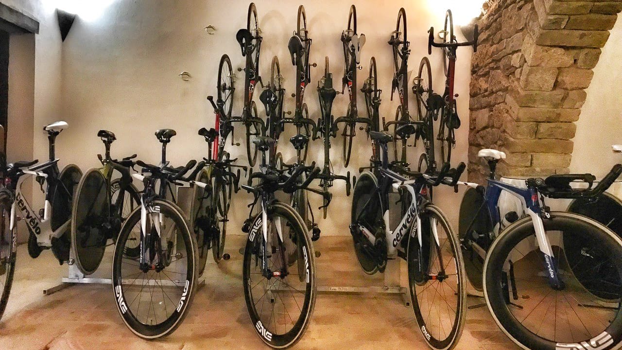 Secure indoor bike storage at Hotel Mas Pelegri with road bikes mounted on wall racks