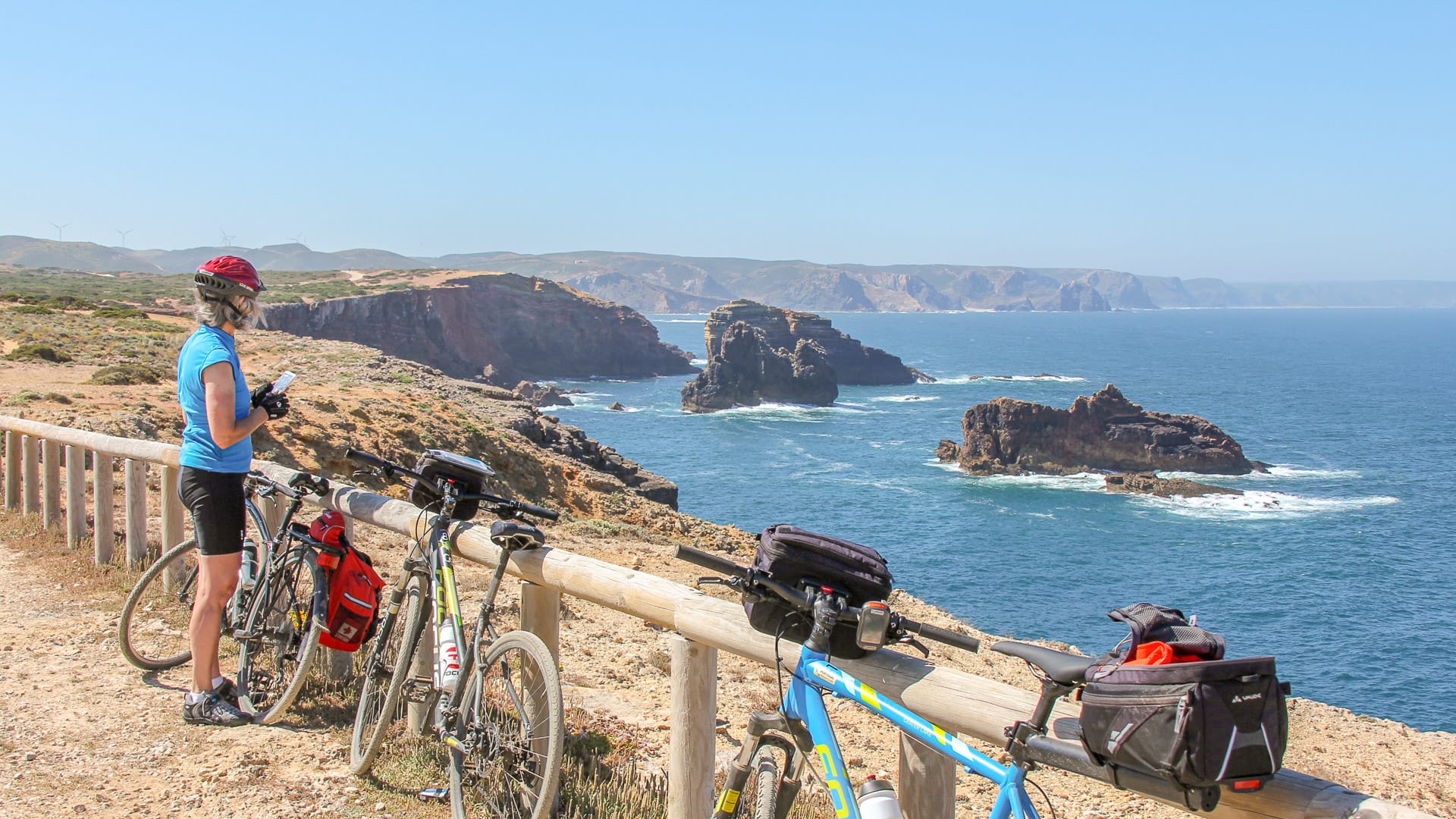 Cyclist stopping to admire the dramatic views along the Portugal Wild Coast
