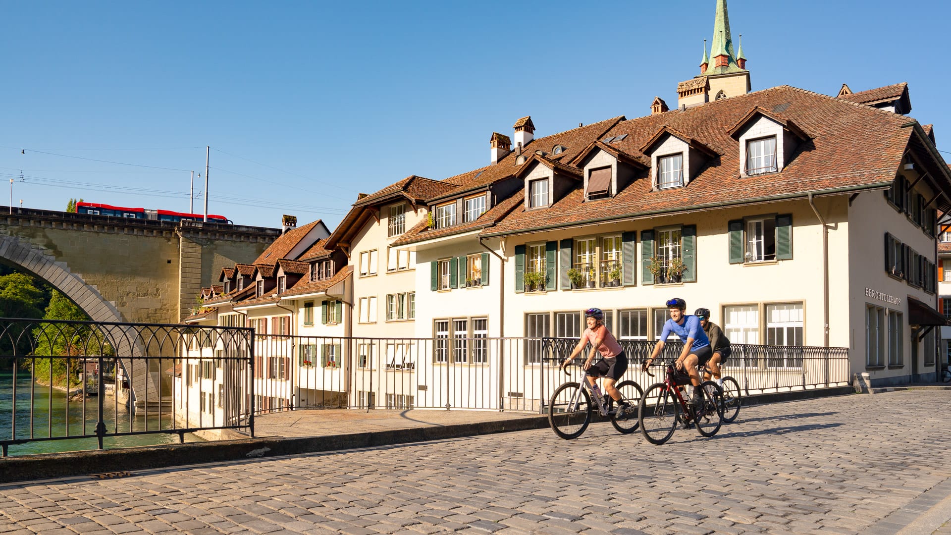 Cyclists riding along a cobblestone path in the Belpberg loop 
