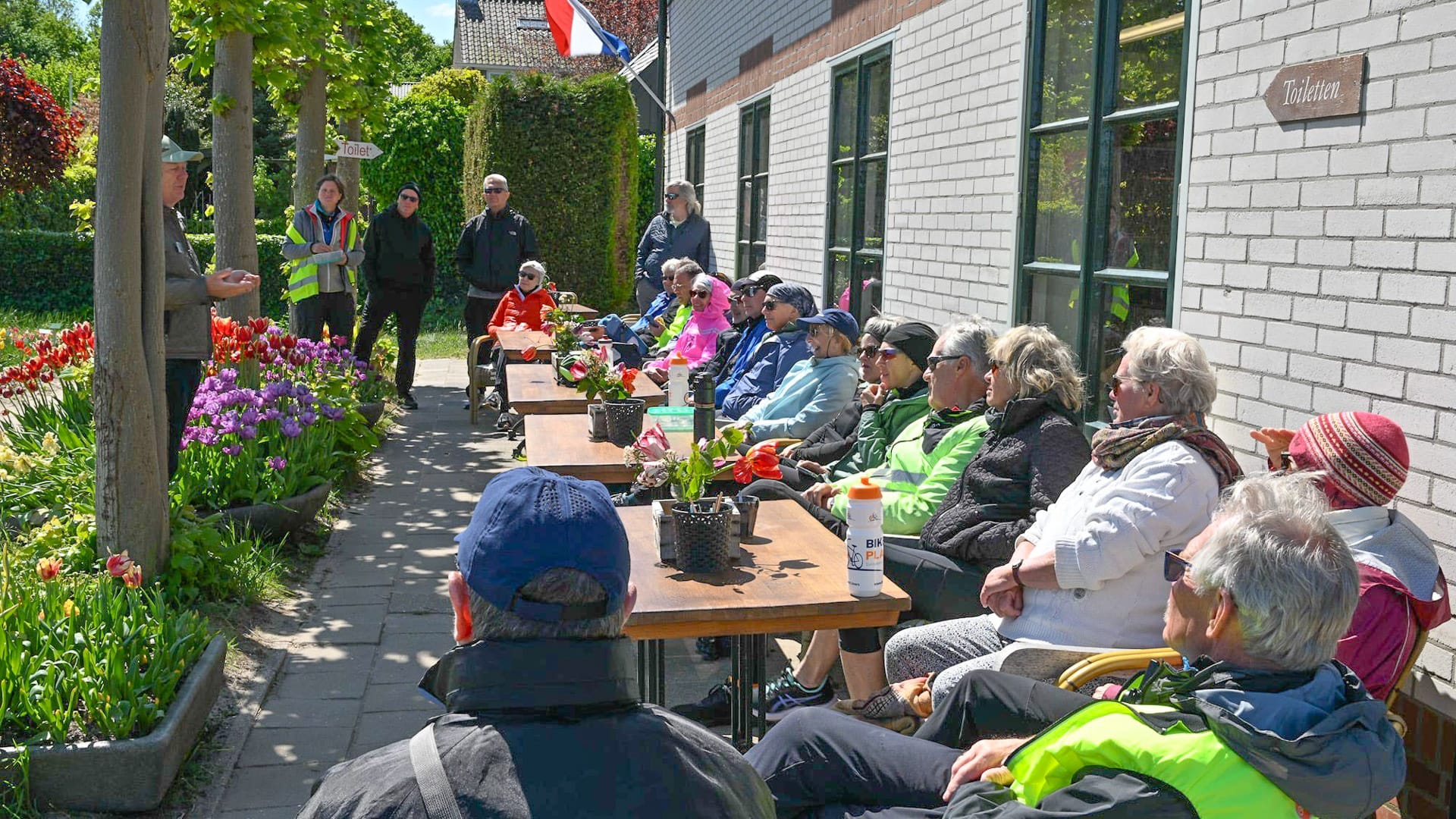 Senior cyclists with a local guide in the tulip gardens at Hortus Bulborum