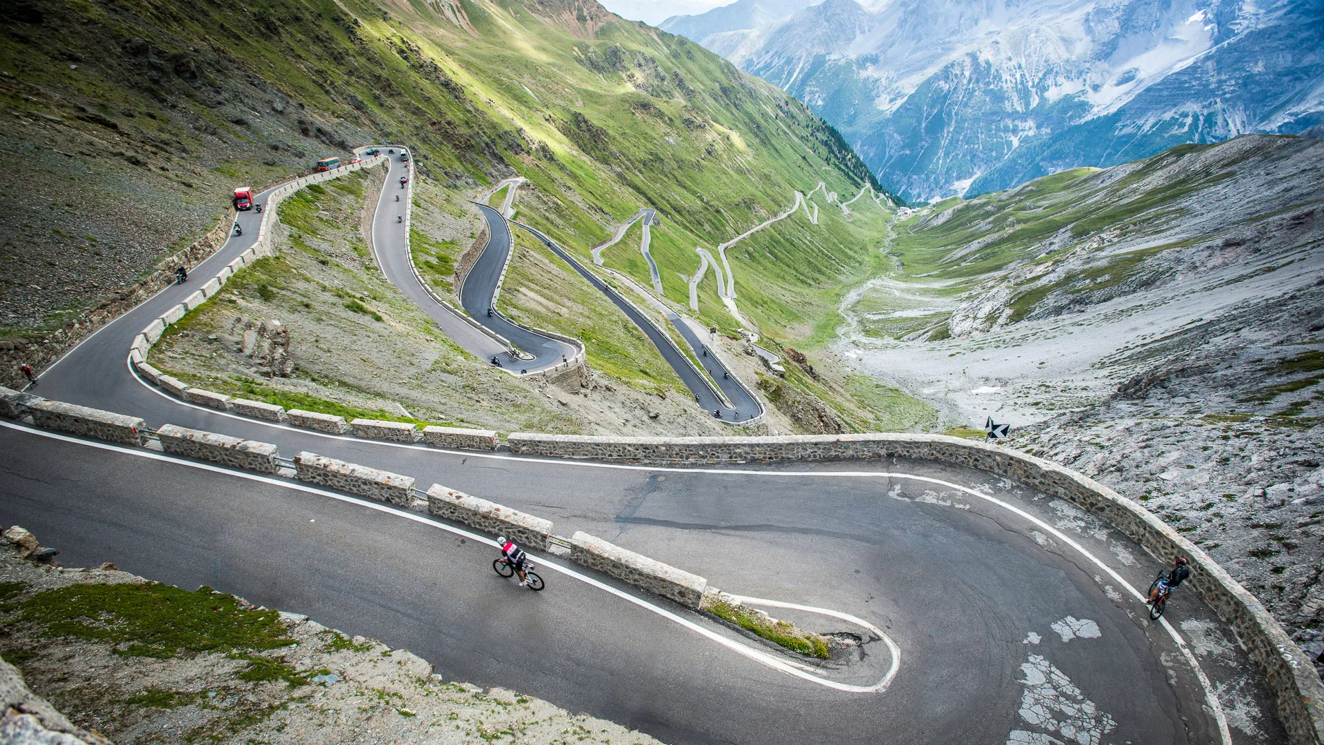 Road cyclist navigating a mountain hairpin bend in Italy on a famous Giro d’Italia climb