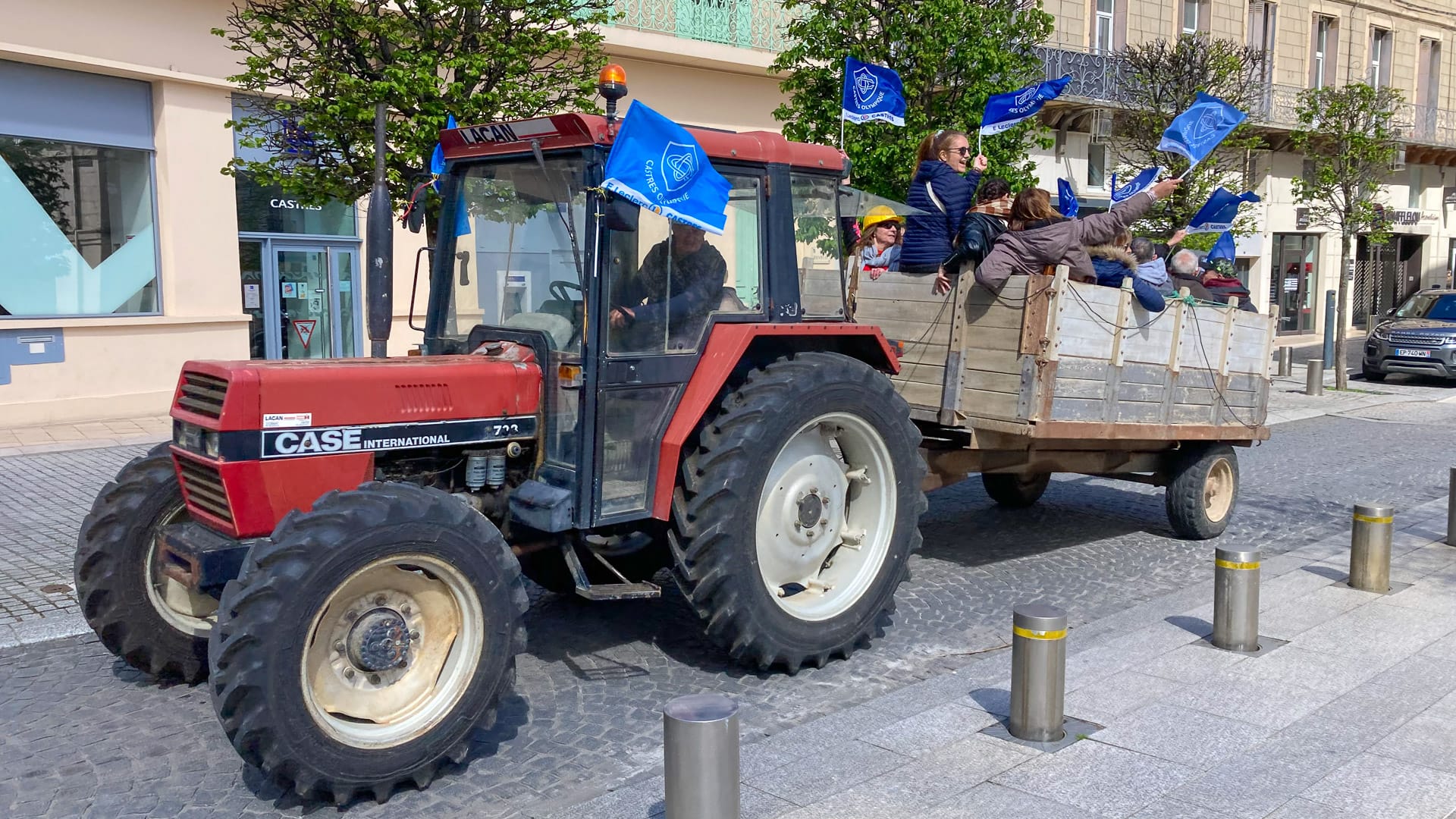 Agricultural tractor passing through a quiet street in France