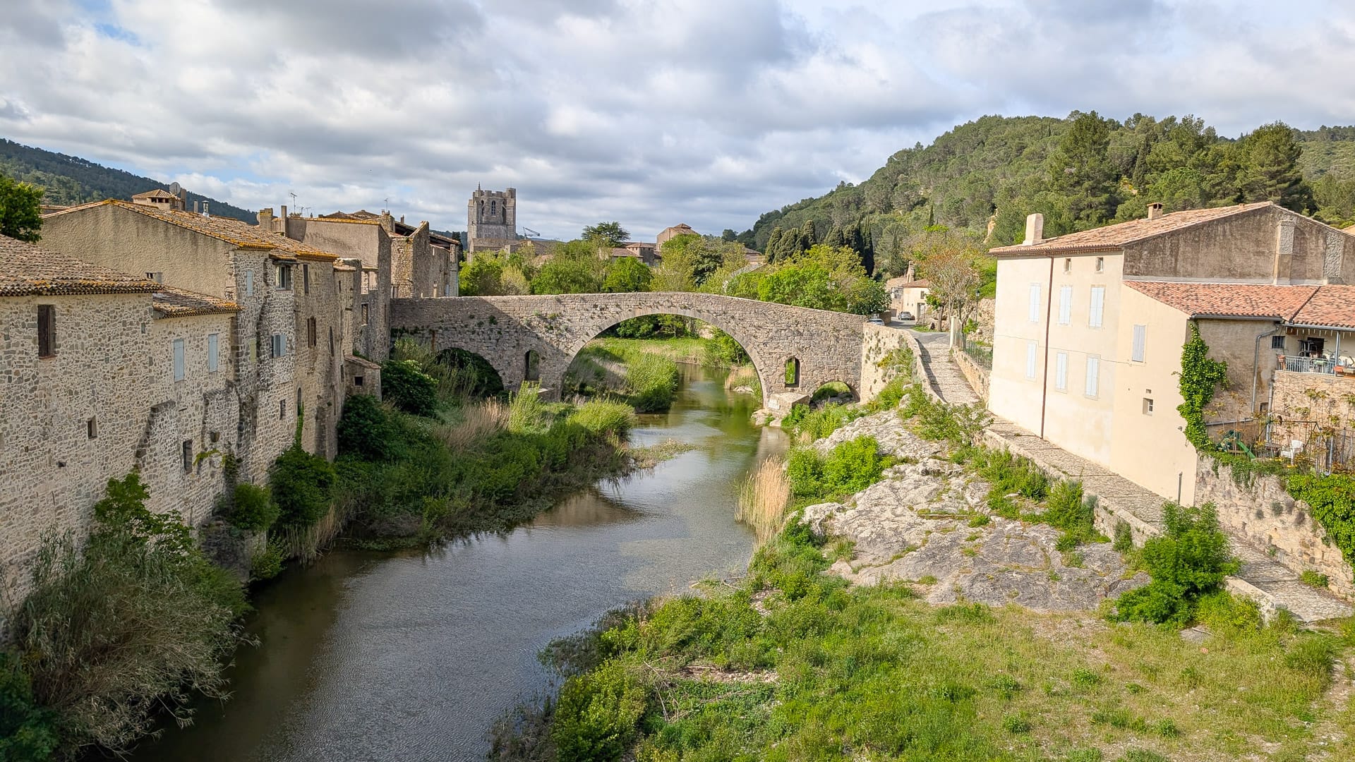 Lagrasse medieval village in France with stone houses, river and historic abbey