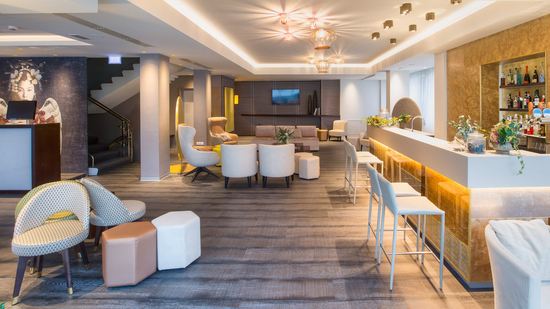 Stylish hotel lobby with modern seating and bar area serving drinks to guests