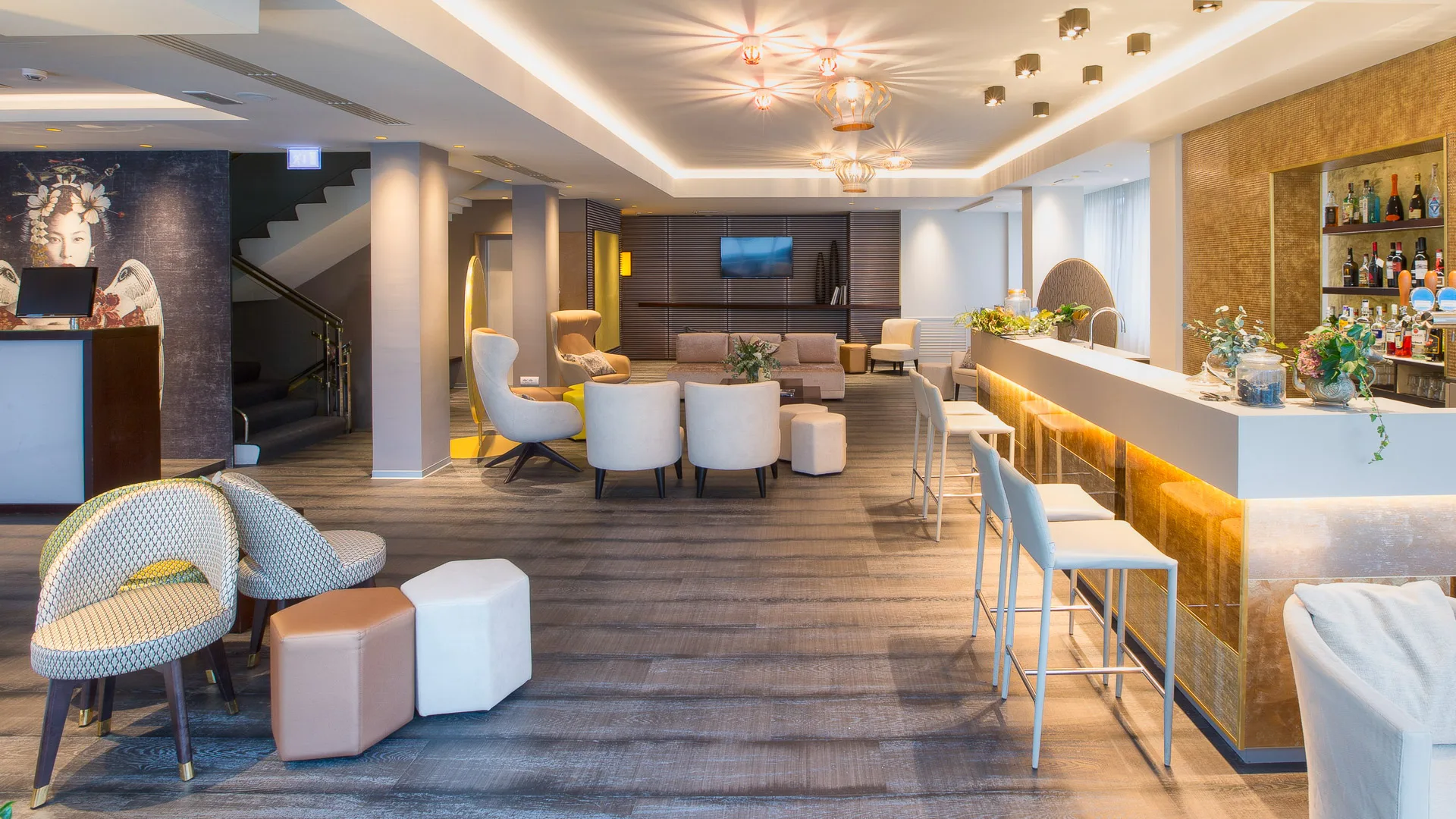 Stylish hotel lobby with modern seating and bar area serving drinks to guests