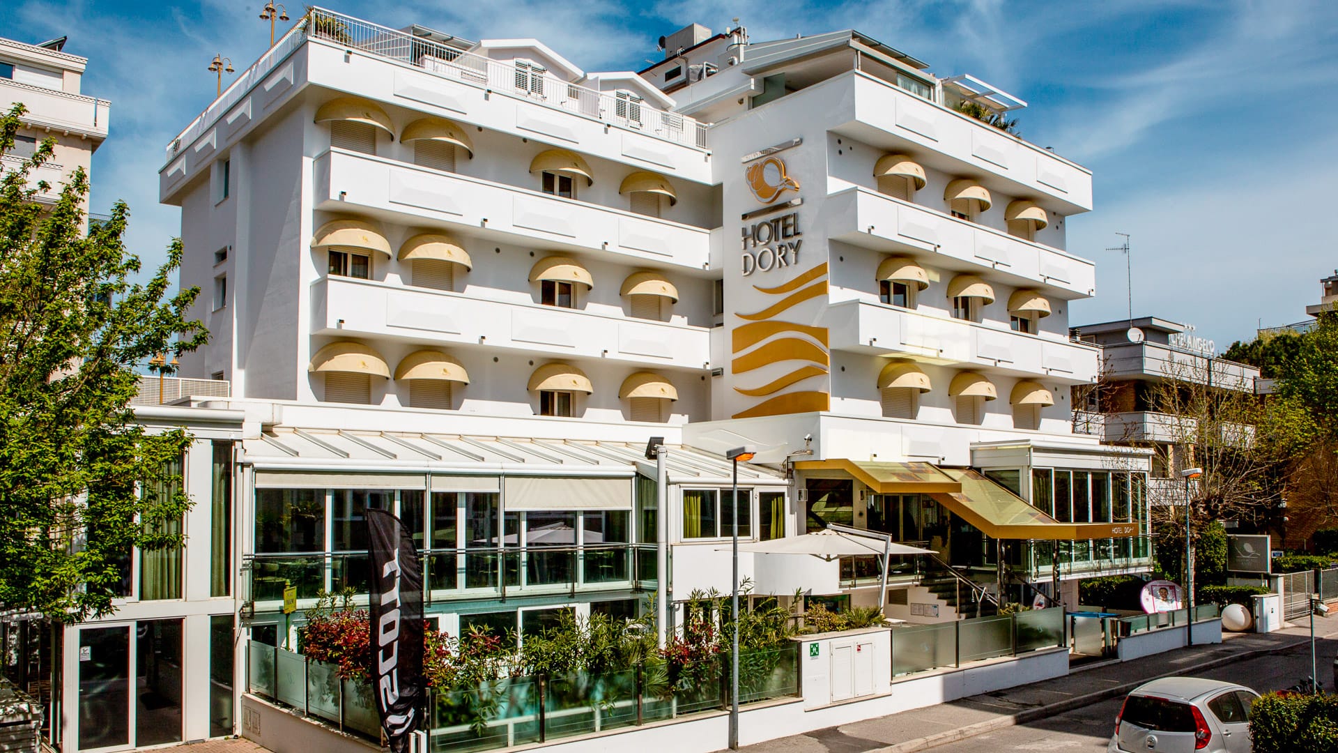 Exterior of Hotel Dory in Riccione, Italy with modern building and entrance area