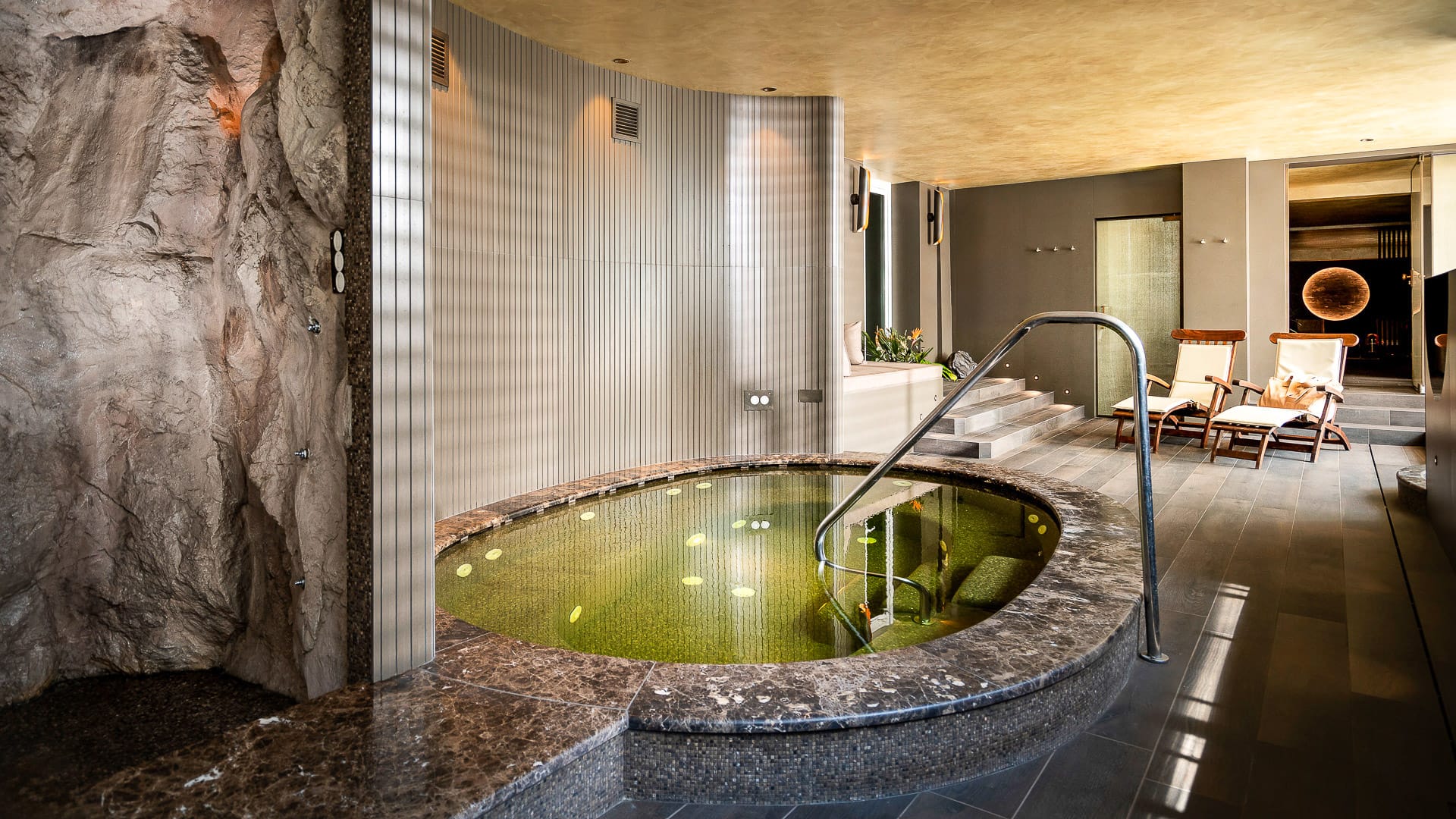 Indoor jacuzzi with tiled surround and relaxing spa setting