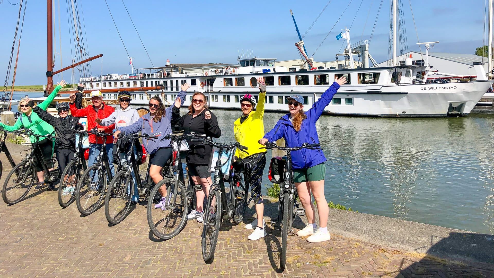 Cyclists posing for a photo in Willemstad in the Netherlands with historic town backdrop