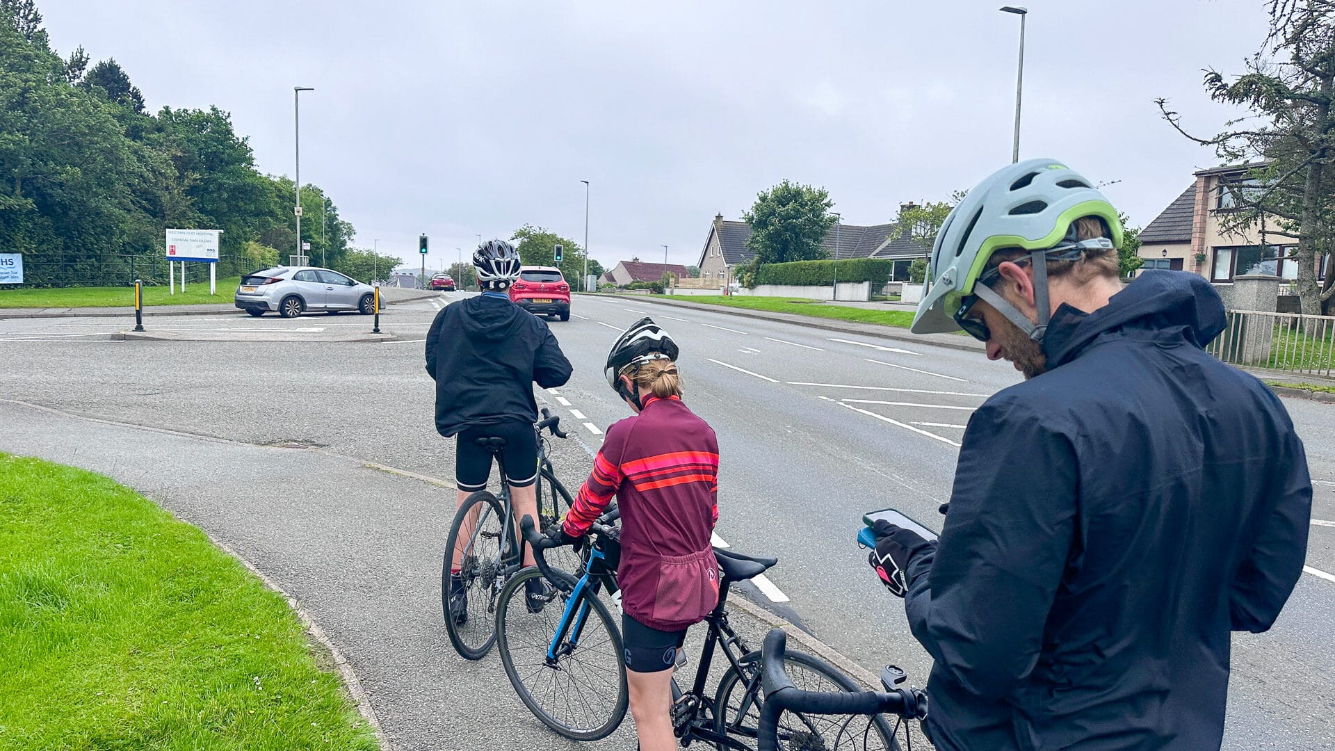 Road cyclist viewing route map on phone during ride