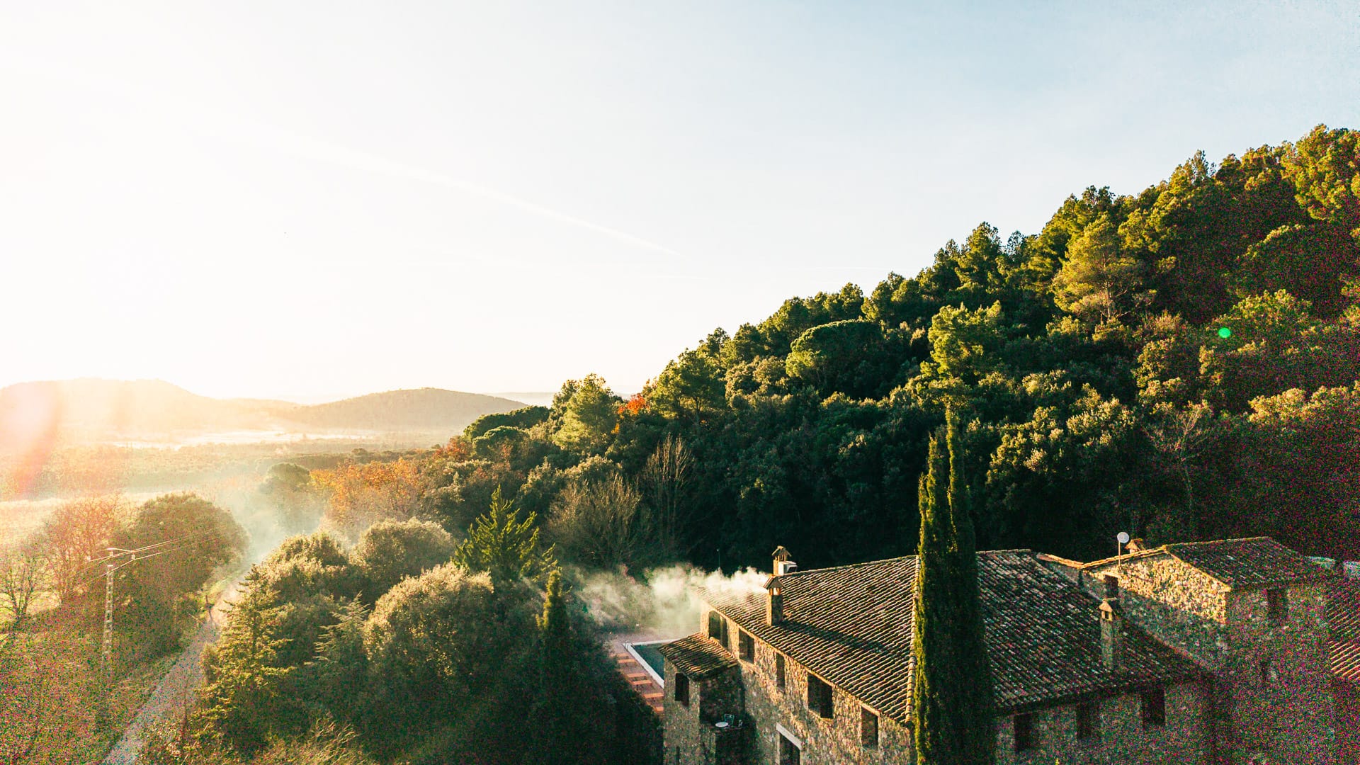 View from Off Grid Girona hotel with trees and mountains on the horizon