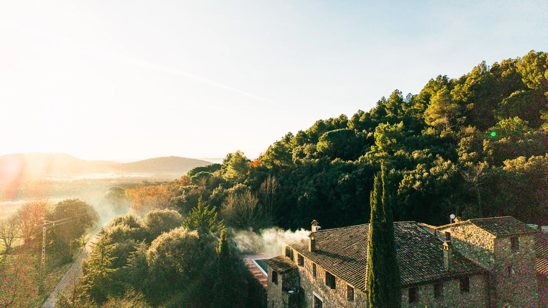 View from Off Grid Girona hotel with trees and mountains on the horizon