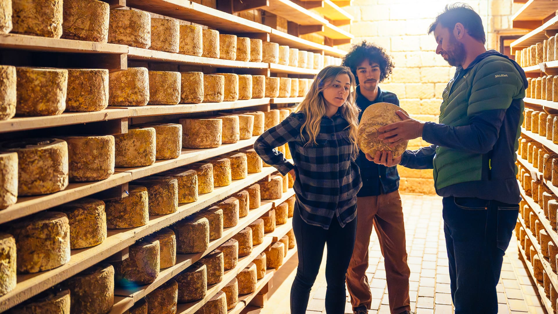 Tourists watching Castelmagno cheese maturing in Grana Valley