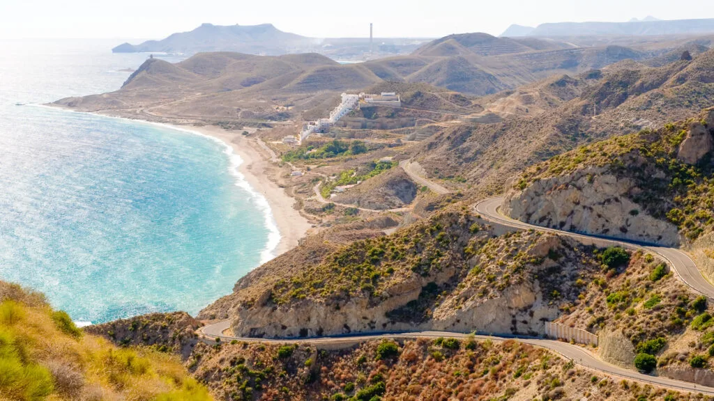 Cycling Andalucia's coastline with road and coast stretching into distance