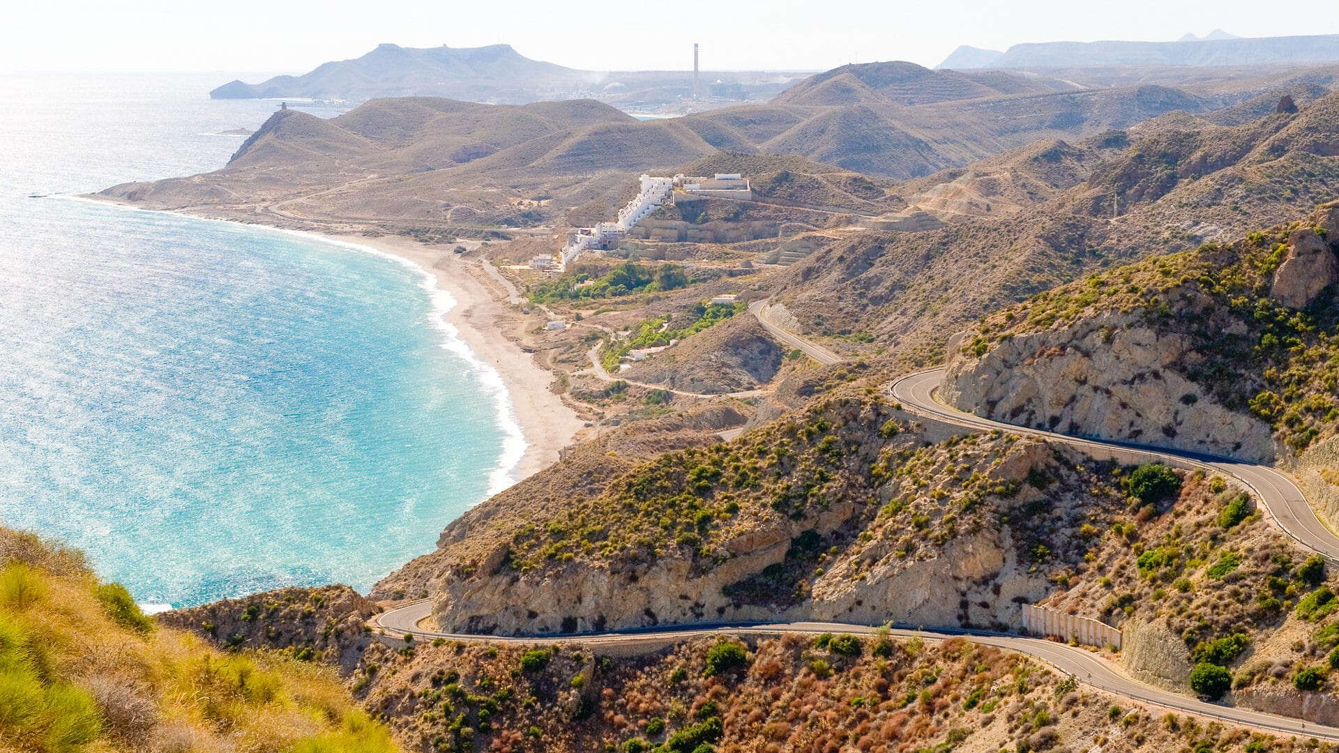 Cycling Andalucia's coastline with road and coast stretching into distance