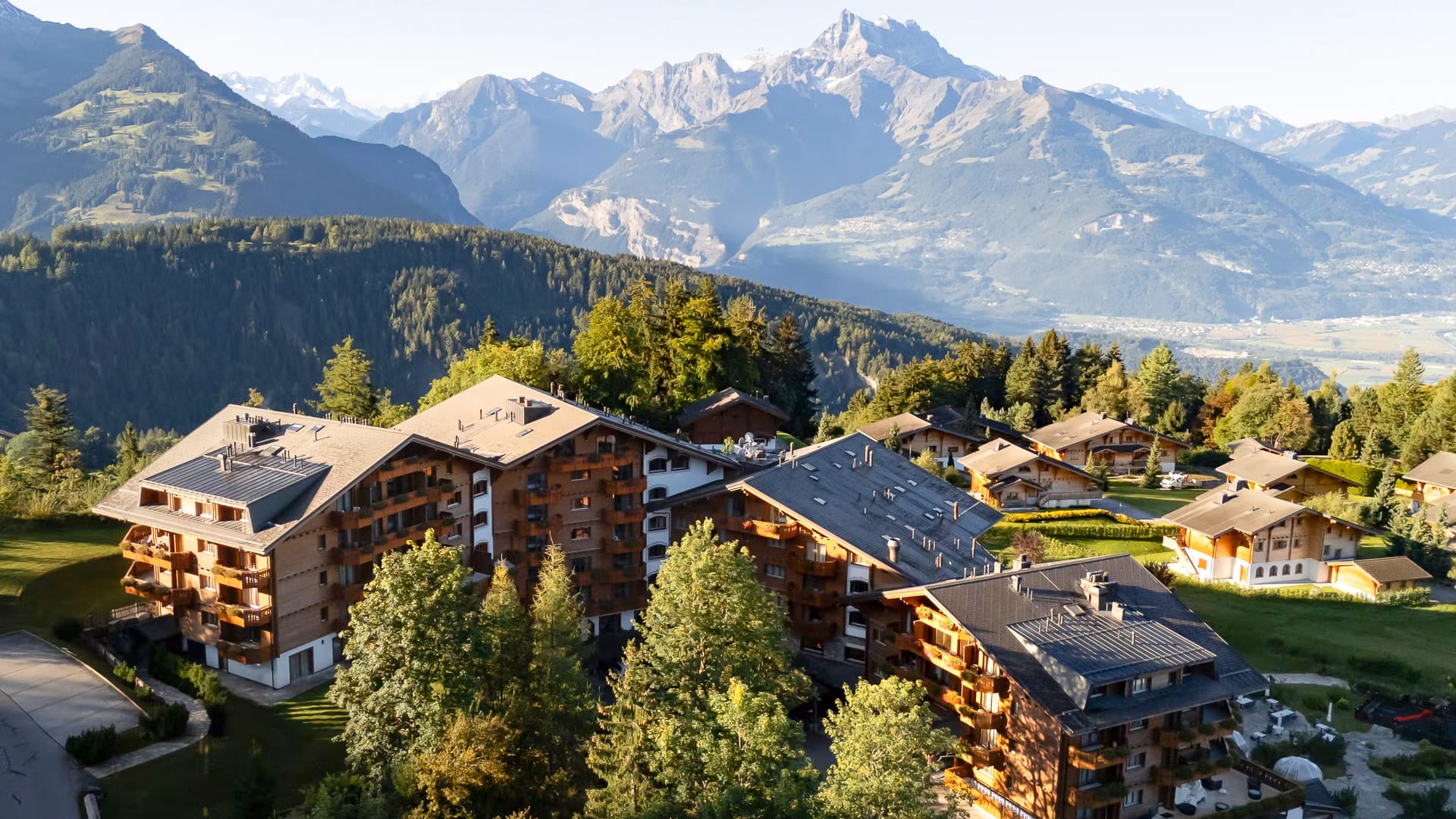Aerial view of Chalet RoyAlp surrounded by dramatic Swiss Alps