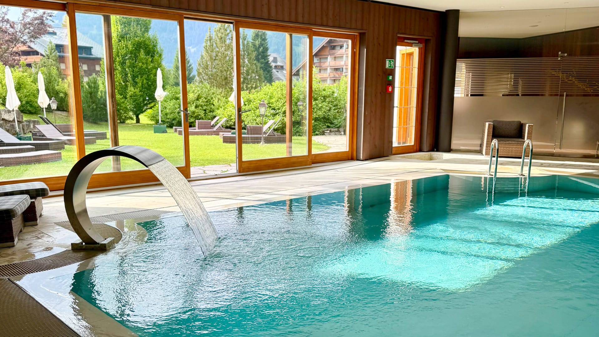 Peaceful spa with glass walls overlooking the alpine scenery at Chalet RoyAlp