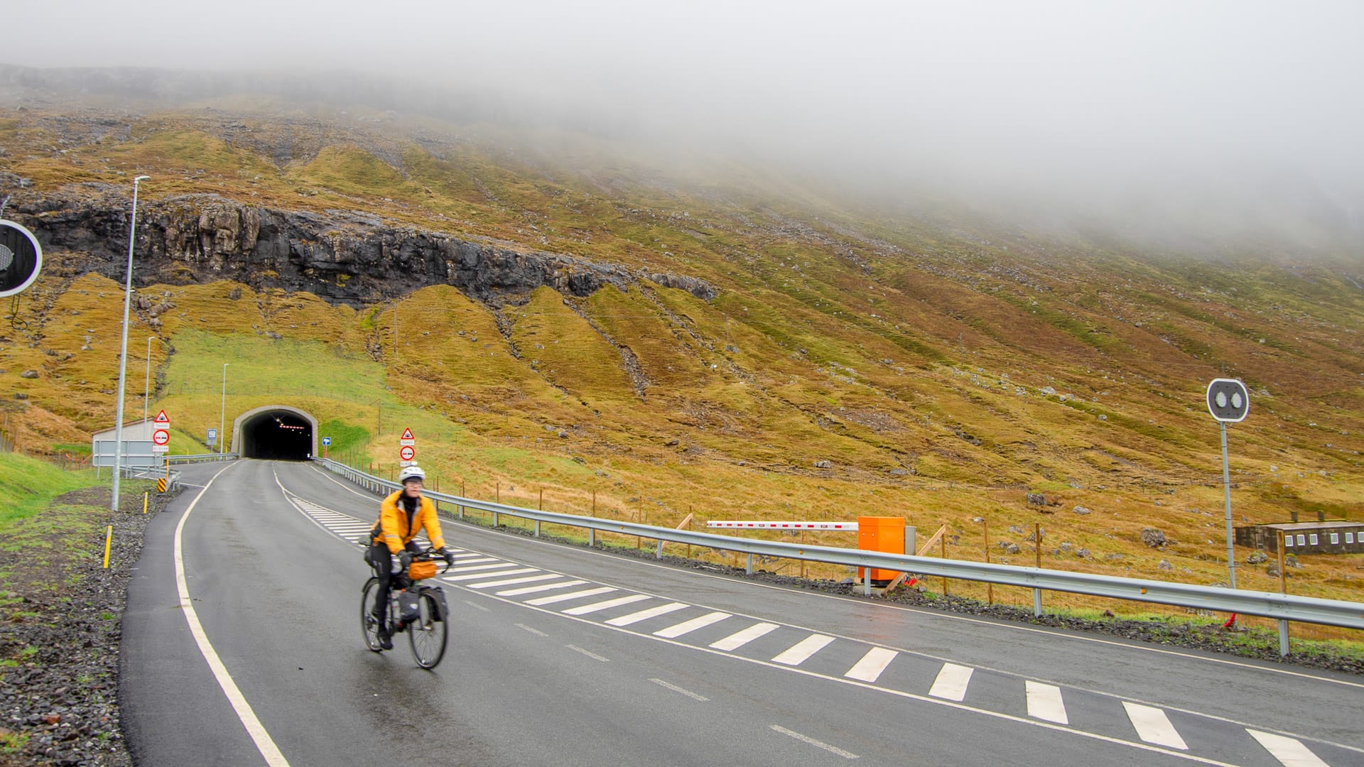 Cyclist in between tunnels in Ánarfjørður