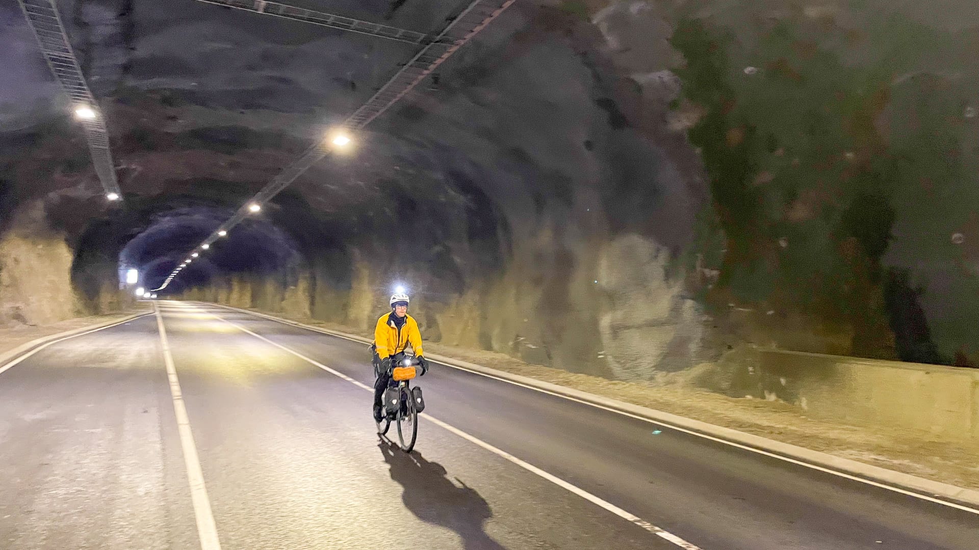 Cyclist tackling the Viðareiðistunnilin mountain tunnel