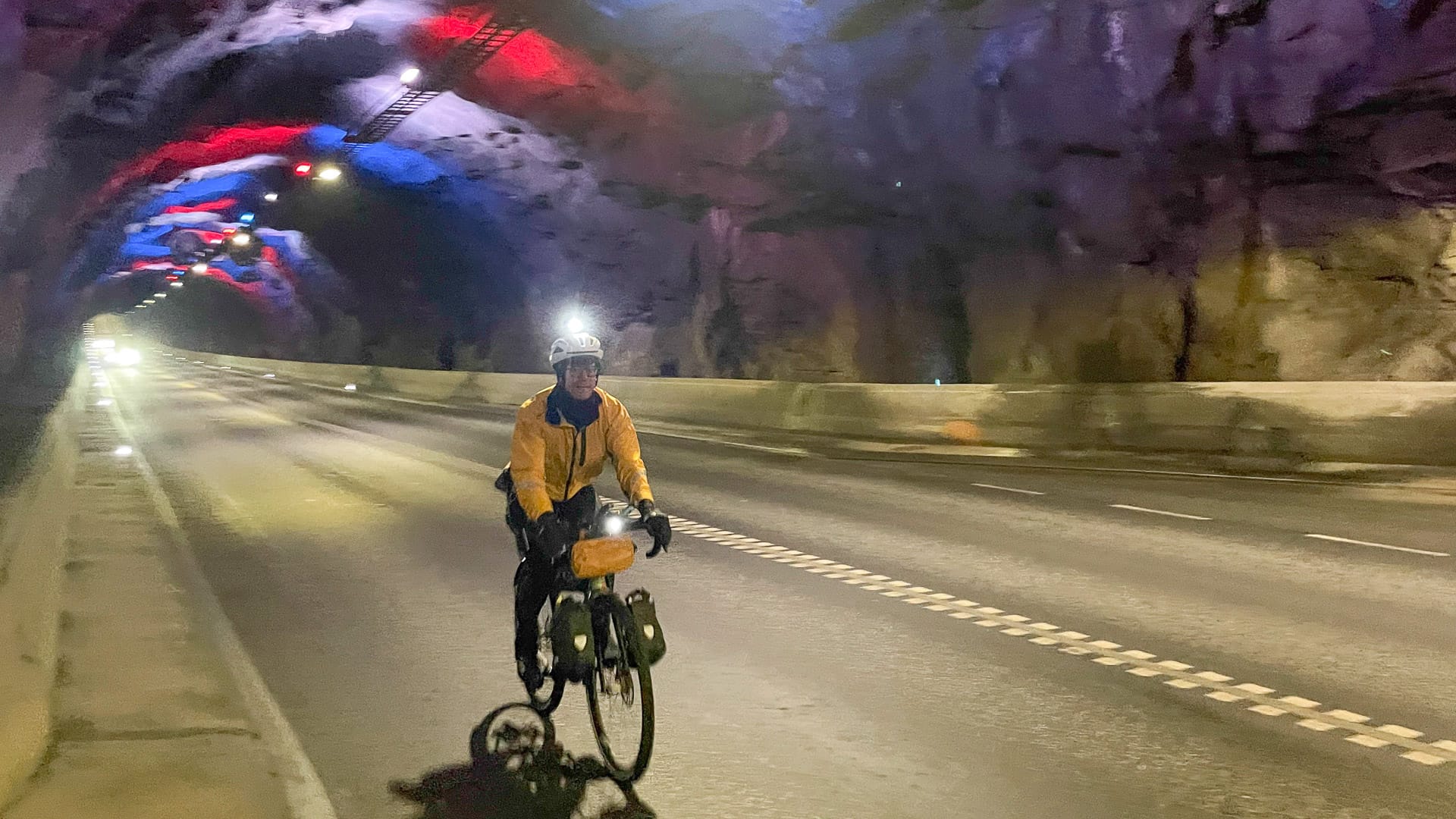 Cyclist on a typical subsea tunnel, the Norðoyatunnilin
