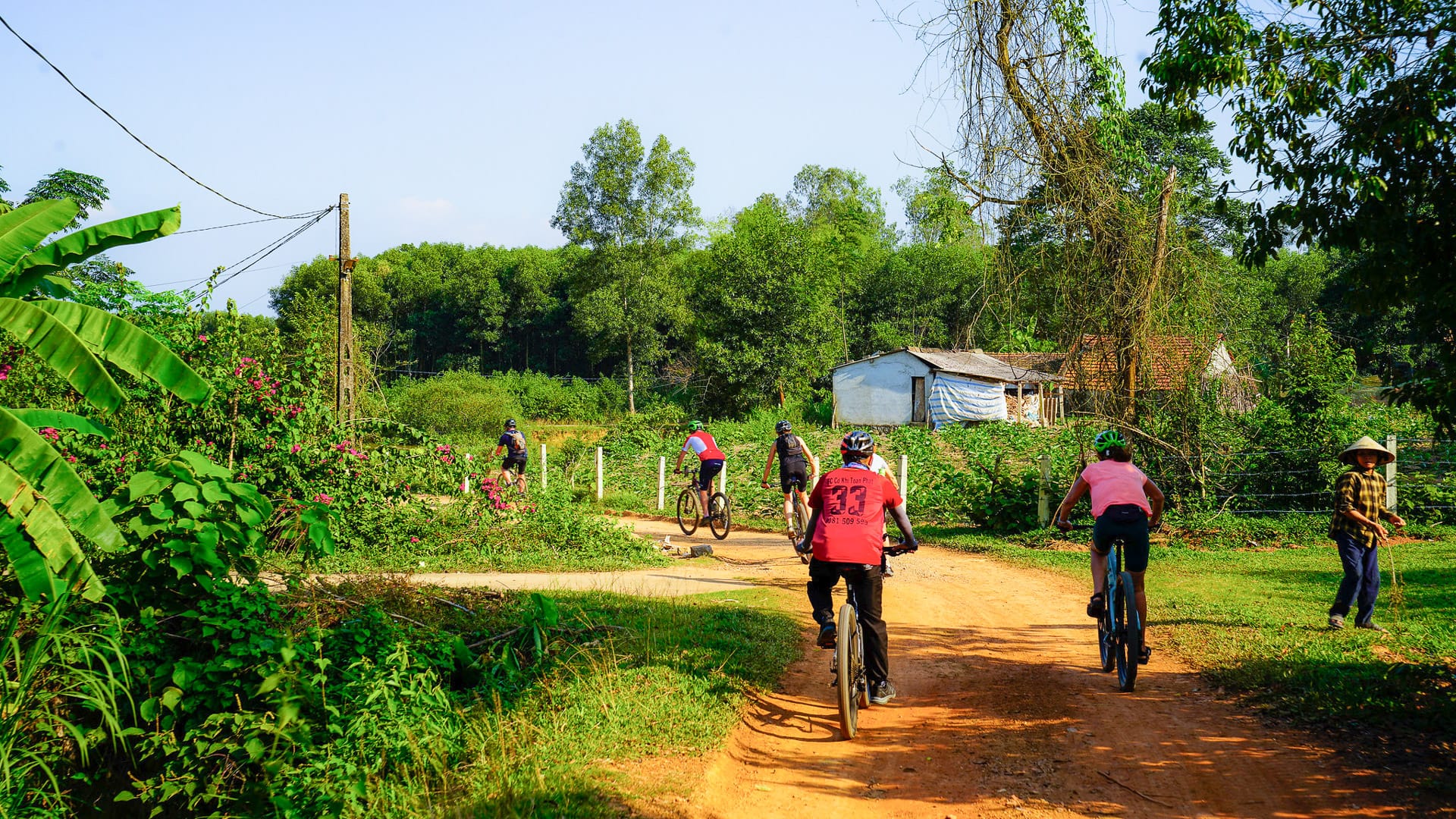 Cycling through rural villages in northern Vietnam with local houses and countryside scenery