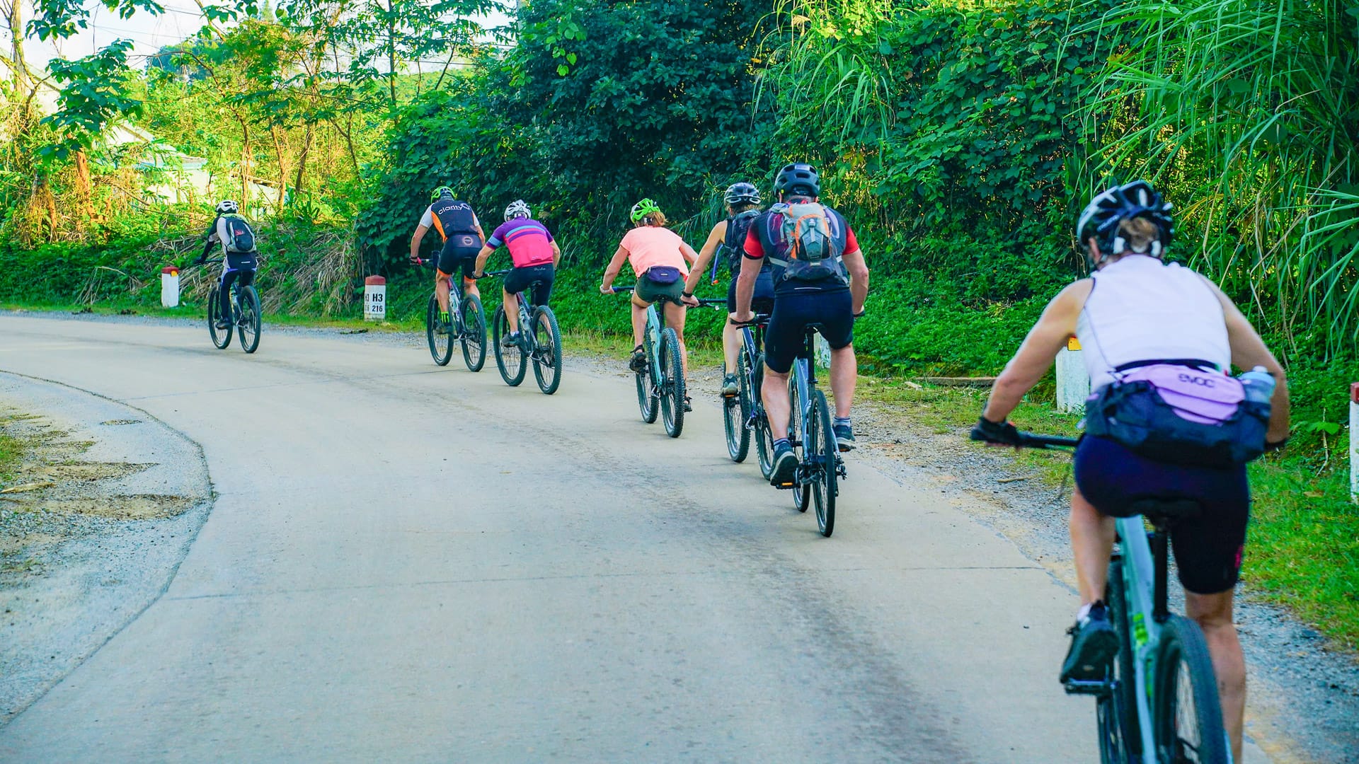 Cyclists riding together in northern Vietnam sharing the joy of group cycling on quiet roads