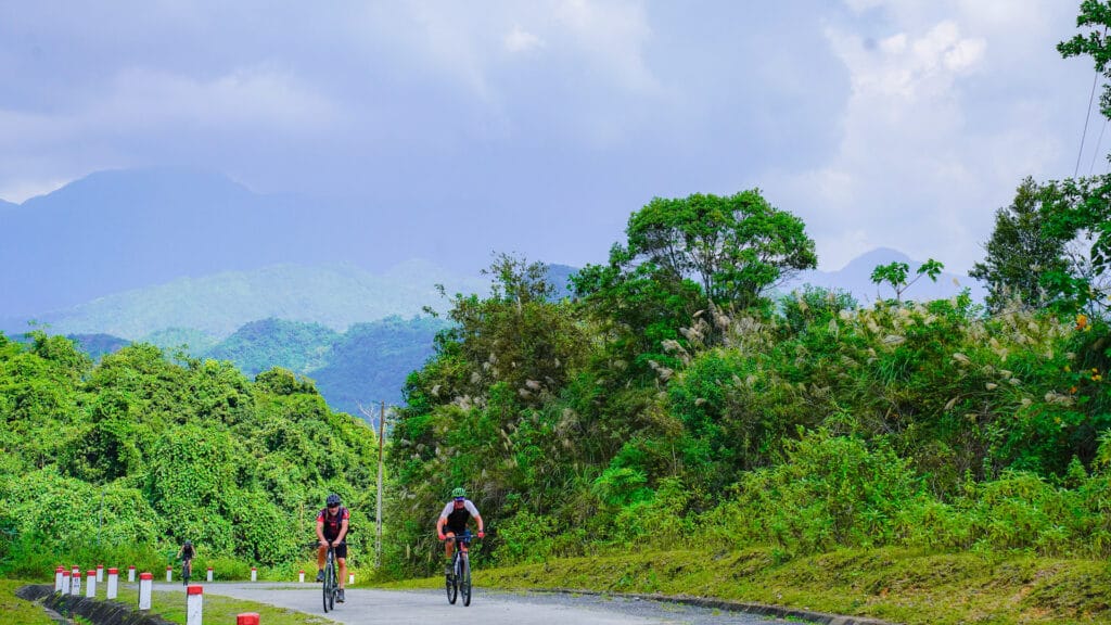 Cycling in northern Vietnam through green forests with lush landscape and quiet roads