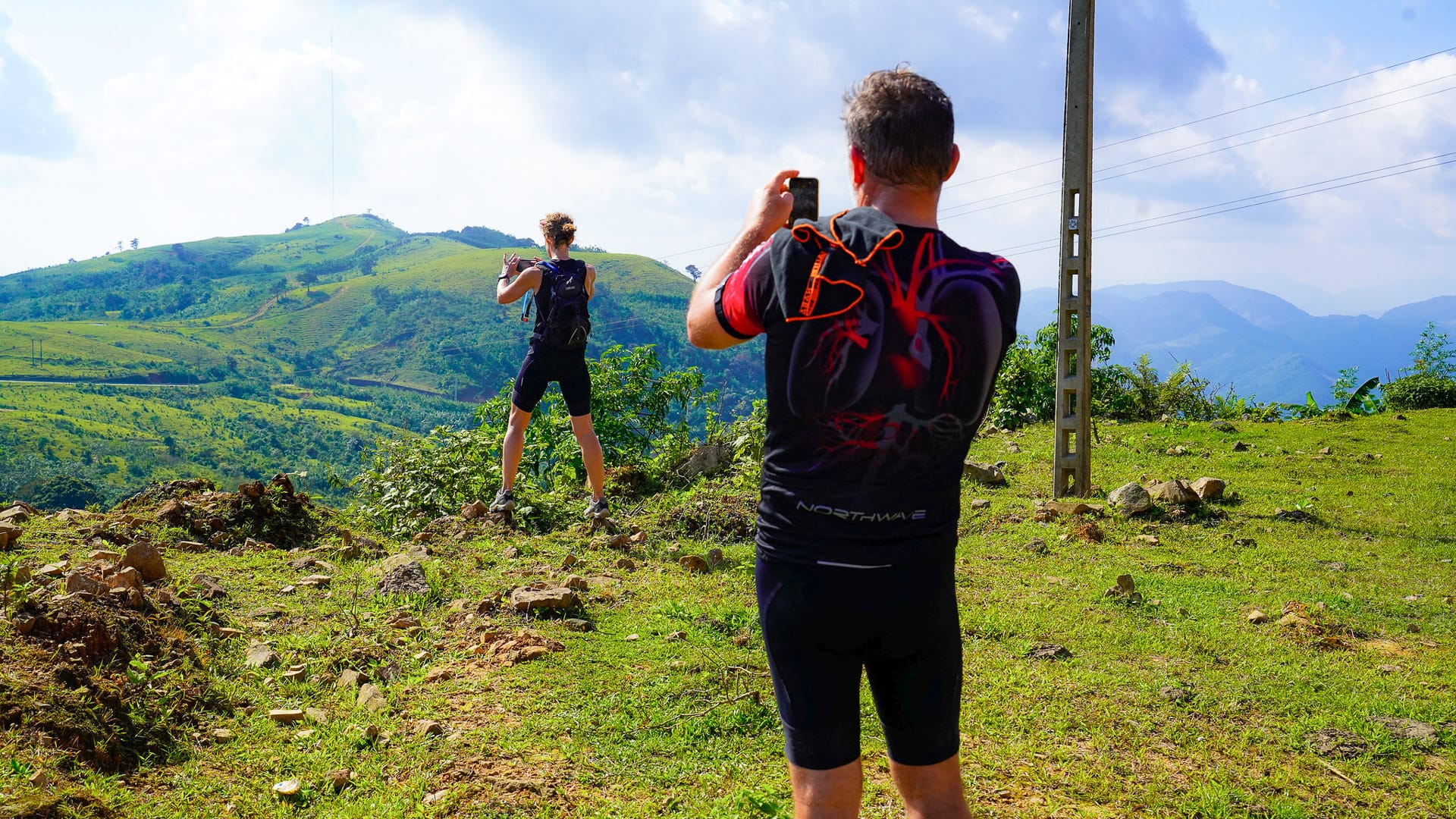 Cyclists riding through northern Vietnam with wide landscape views showing the country in perspective