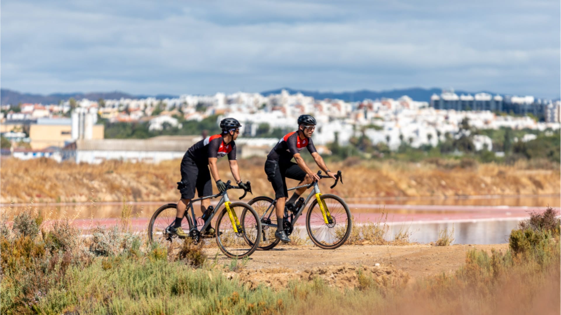 Cyclist exploring the salt pans in Ria Formosa near Tavira, Algarve