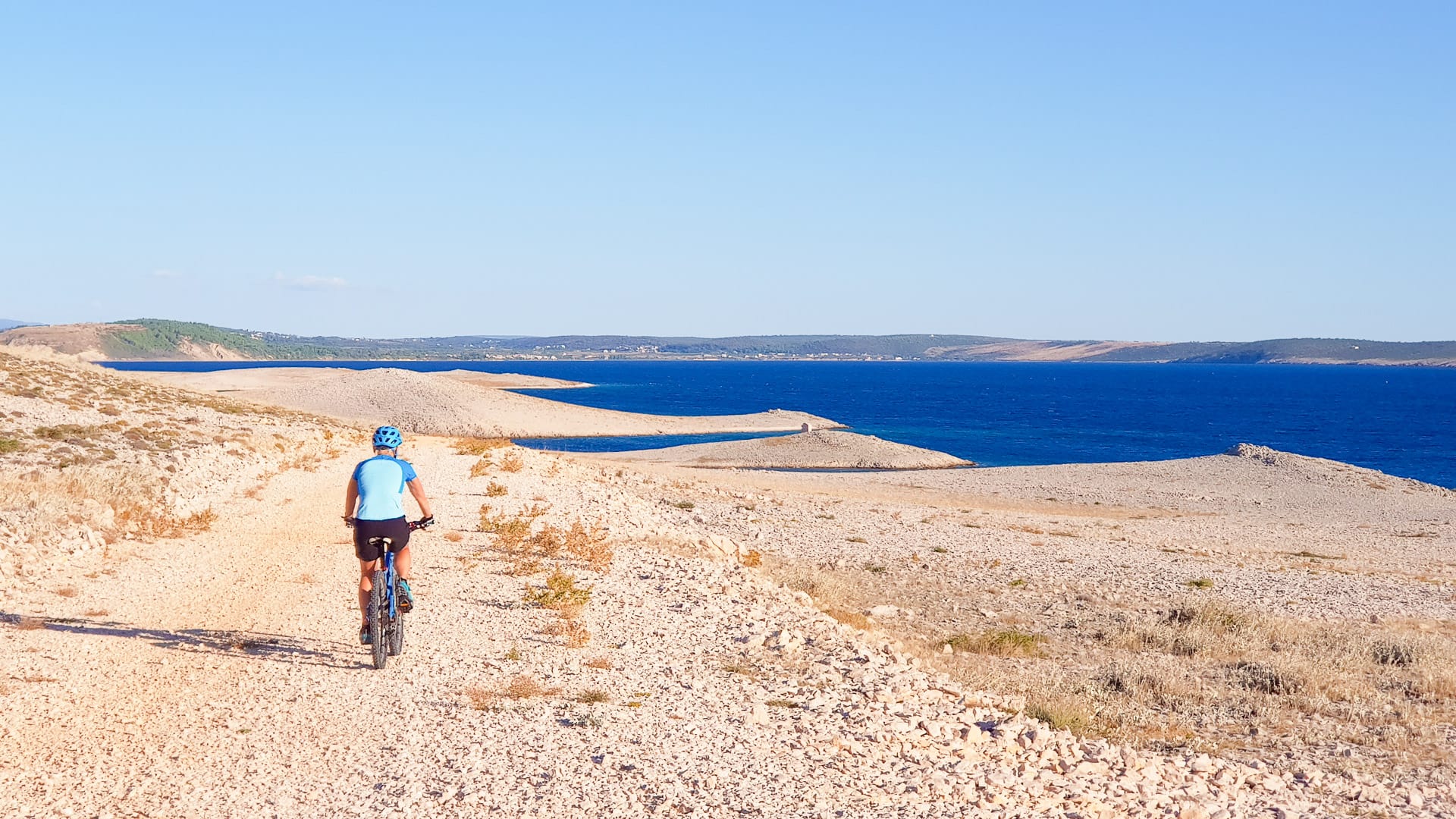 Cyclist on the “moonlike landscape” on the island of Pag