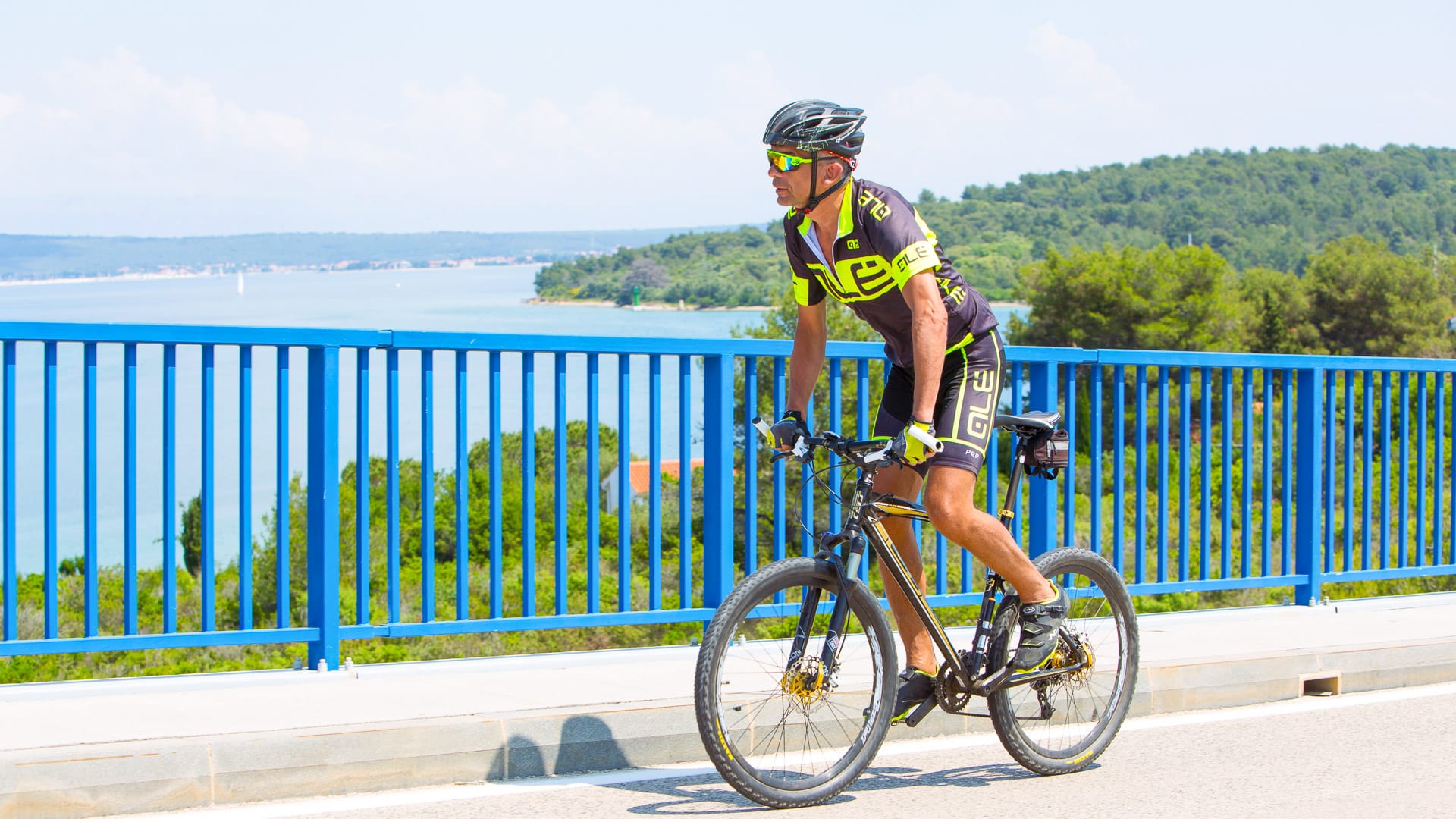 Cyclist riding the bridge connecting the islands of Ugljan and Pašman